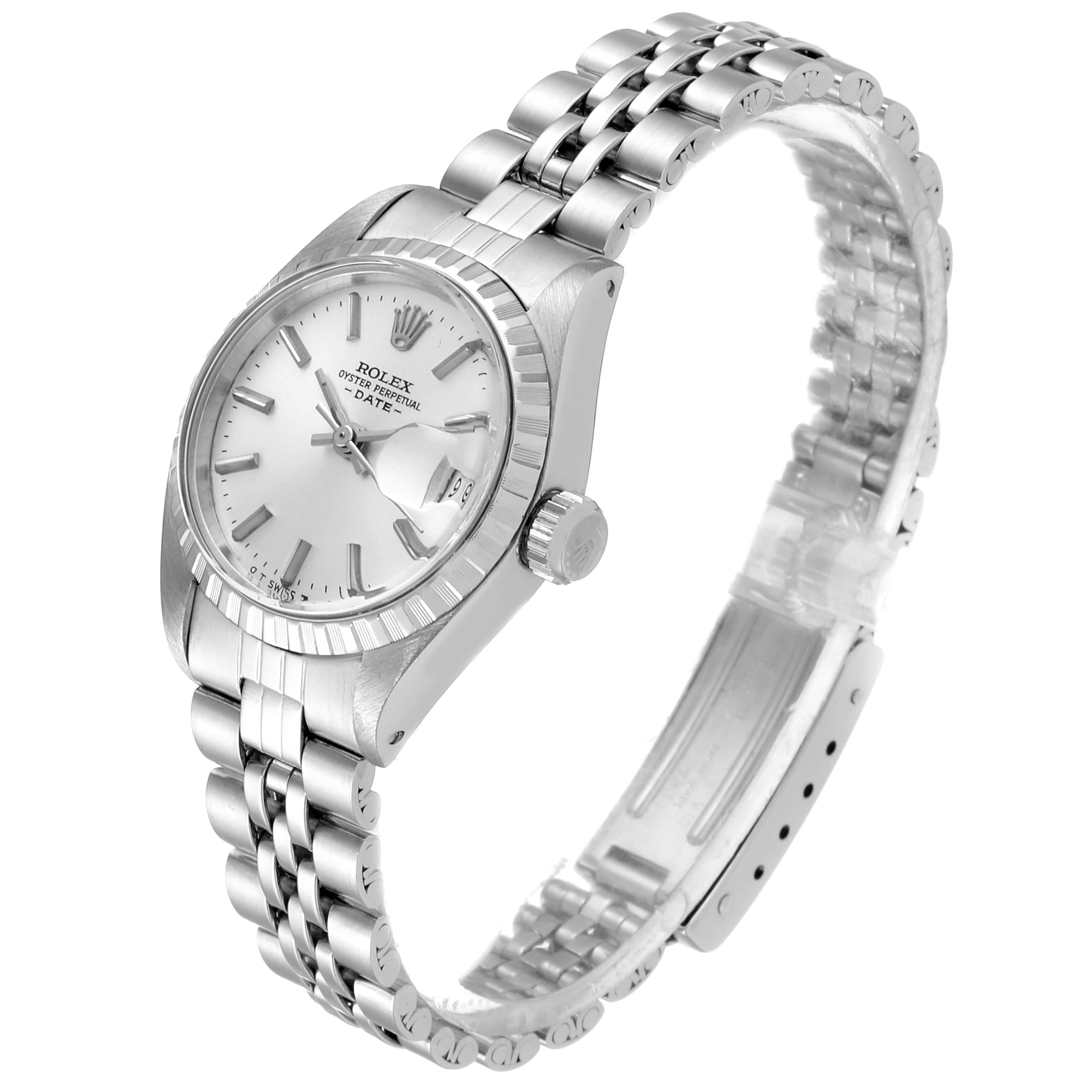 The image shows a Rolex Date 6924 Women
s Stainless Steel Silver Dial 6924 Women
s Stainless Steel Silver Dial watch from a 3/4 angle, displaying the face, crown, and metal bracelet.