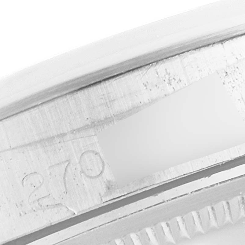 This close-up image shows a section of the bezel and part of the case of a Rolex Vintage Collection 15000 Men
s Stainless Steel Silver Dial 15000 Men
s Stainless Steel Silver Dial model watch.