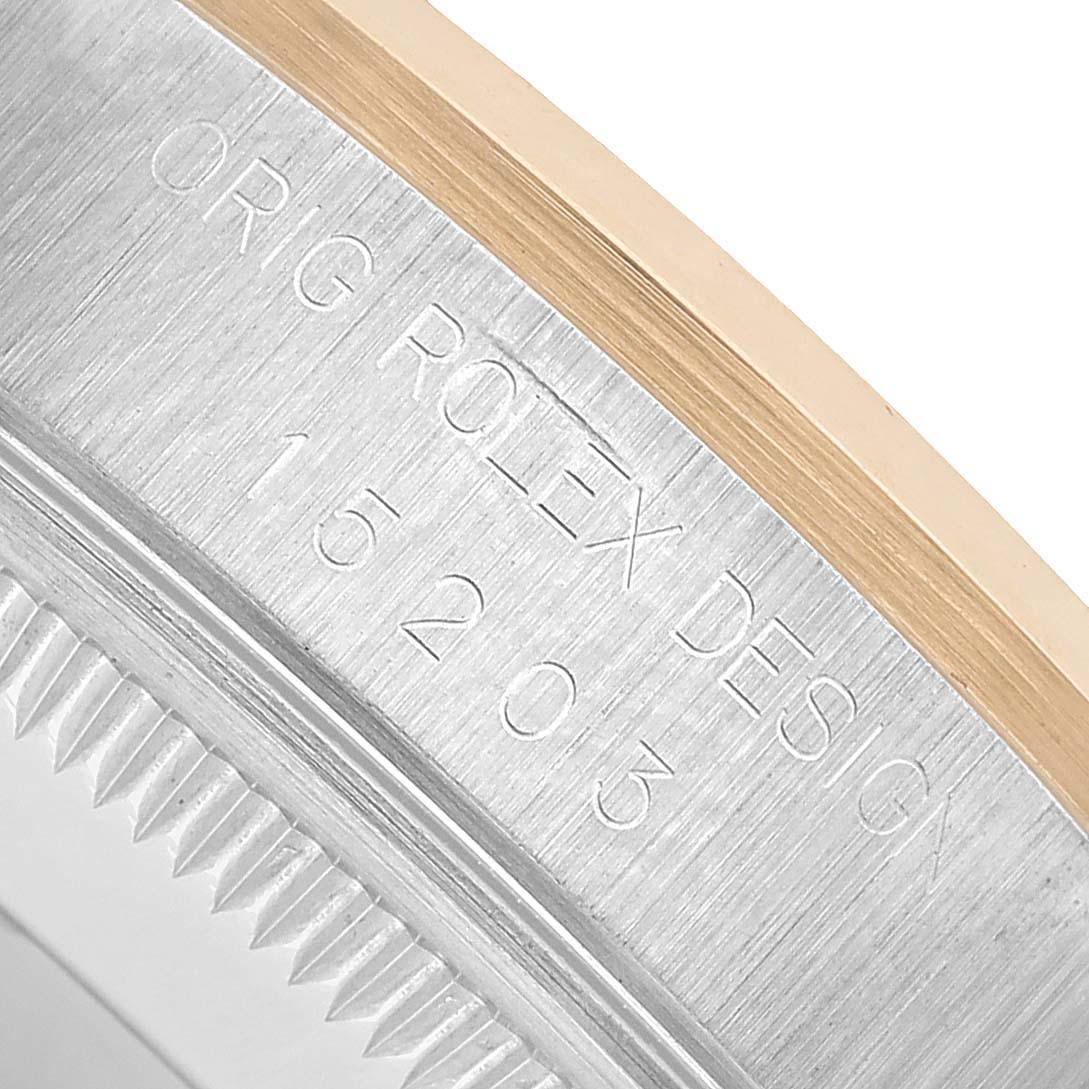 This close-up image shows the engraved edge and bezel of the Rolex Date 15203 Men's Steel and Gold (two tone) Champagne Dial model watch.