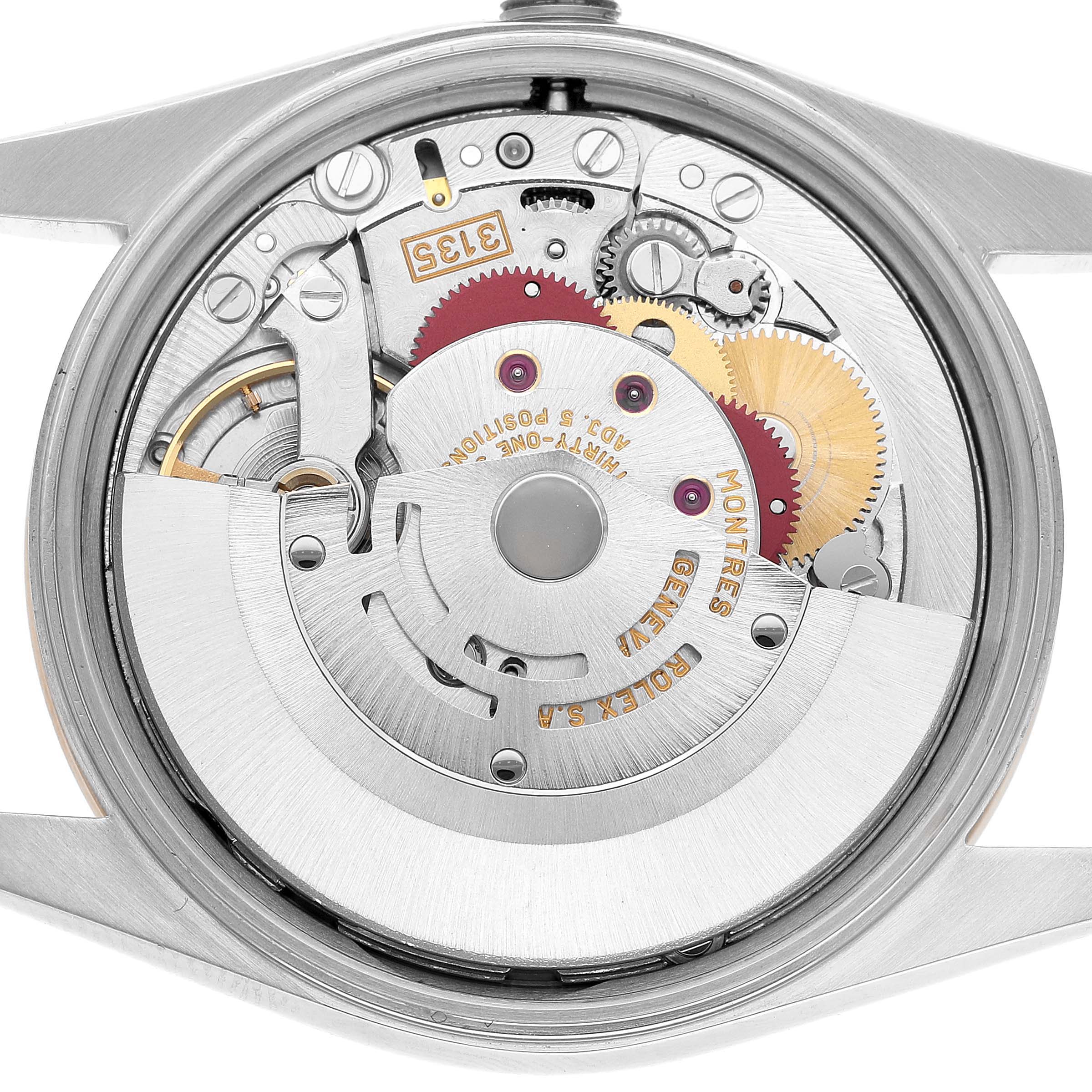 The image shows the movement of a Rolex Date 15203 Men's Steel and Gold (two tone) Champagne Dial model, focusing on the intricate internal gears and components from the back angle.