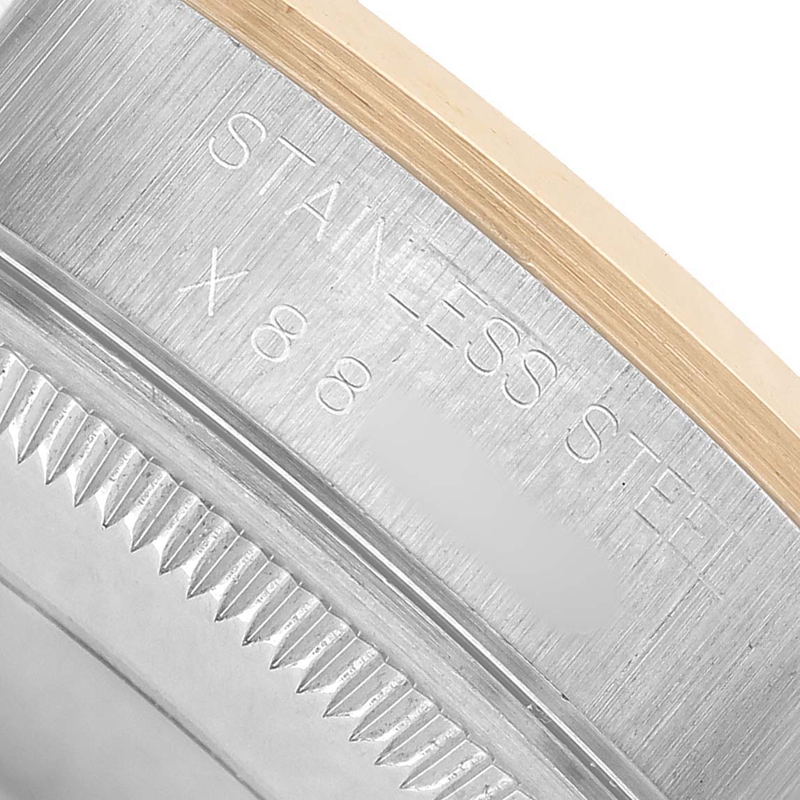 The image shows the side view of a Rolex Date 15203 Men's Steel and Gold (two tone) Champagne Dial model, focusing on the stainless steel case and serrated bezel.