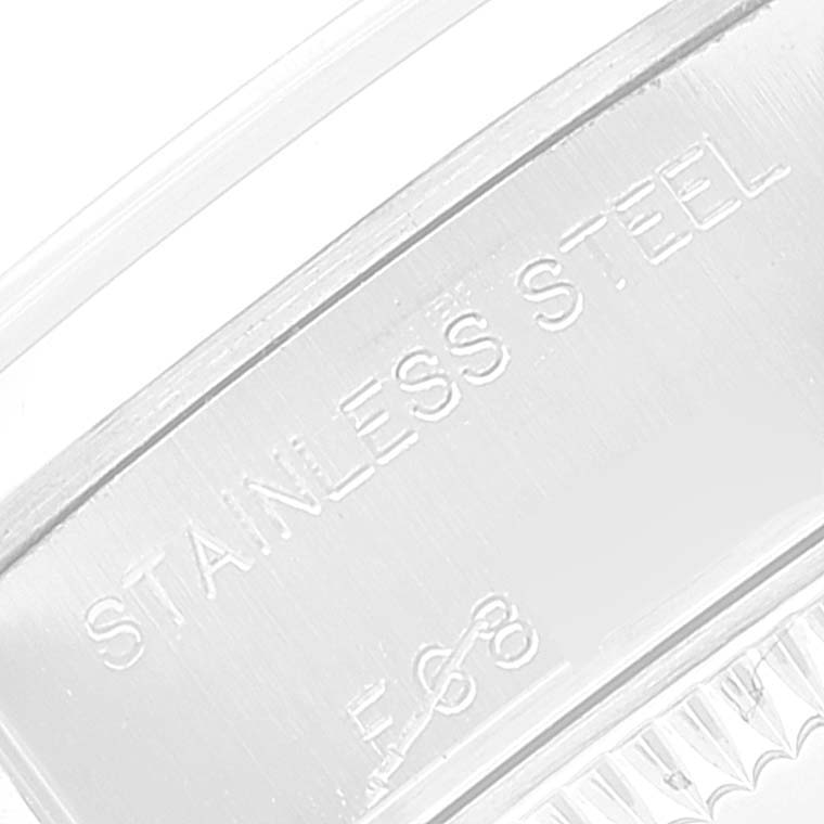 This zoomed-in image shows part of the stainless steel bracelet or case back of a Rolex Date 79160 Women's Stainless Steel White Dial 79160 Women's Stainless Steel White Dial model watch.