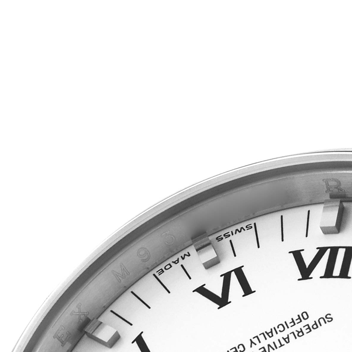 The image shows a partial view of the Rolex Date 115200 Men's Stainless Steel White Dial watch's inner bezel and part of the dial, emphasizing the Roman numerals.