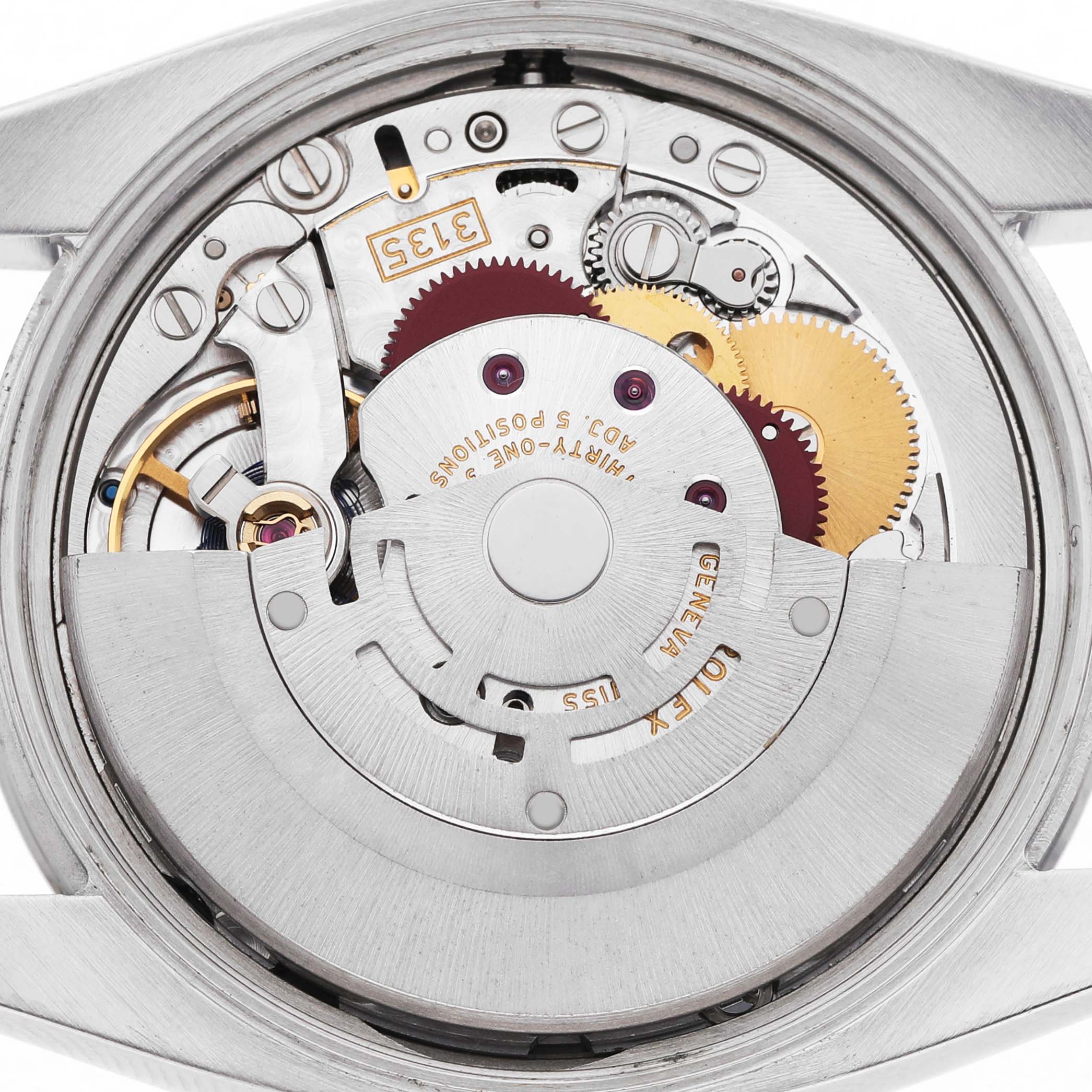 The image shows the internal movement of a Rolex Date 115200 Men's Stainless Steel White Dial model watch from a rear angle, highlighting gears and components.