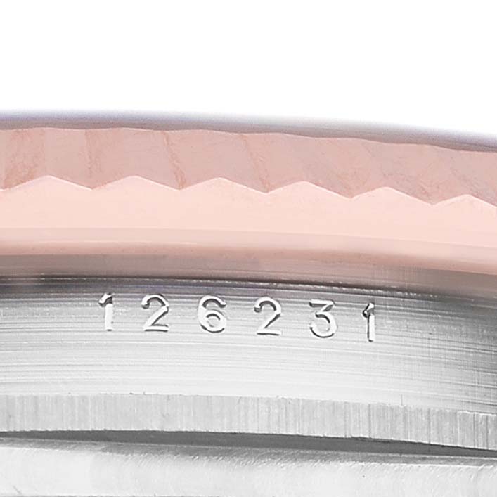 The image shows a close-up of the model number engraved on the side of the Rolex Datejust 126231 Men's Steel and Gold (two tone) Black Dial's case, with a glimpse of the fluted bezel.
