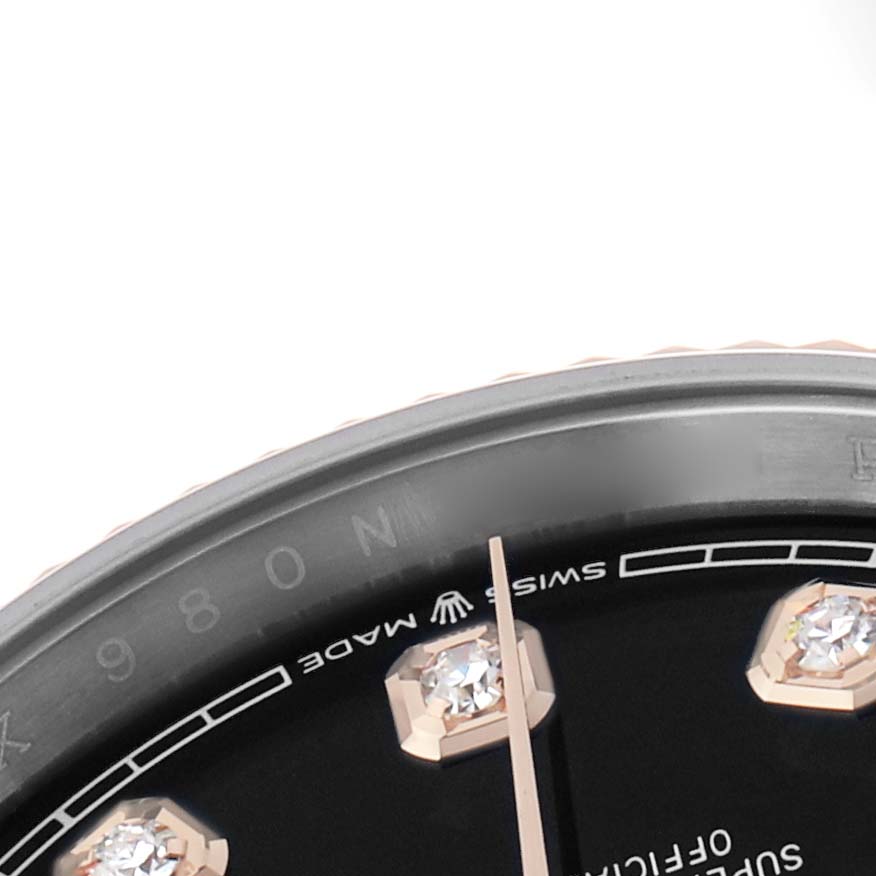 The image shows a close-up of the Rolex Datejust 126231 Men's Steel and Gold (two tone) Black Dial dial, featuring diamond hour markers and a portion of the minute hand.