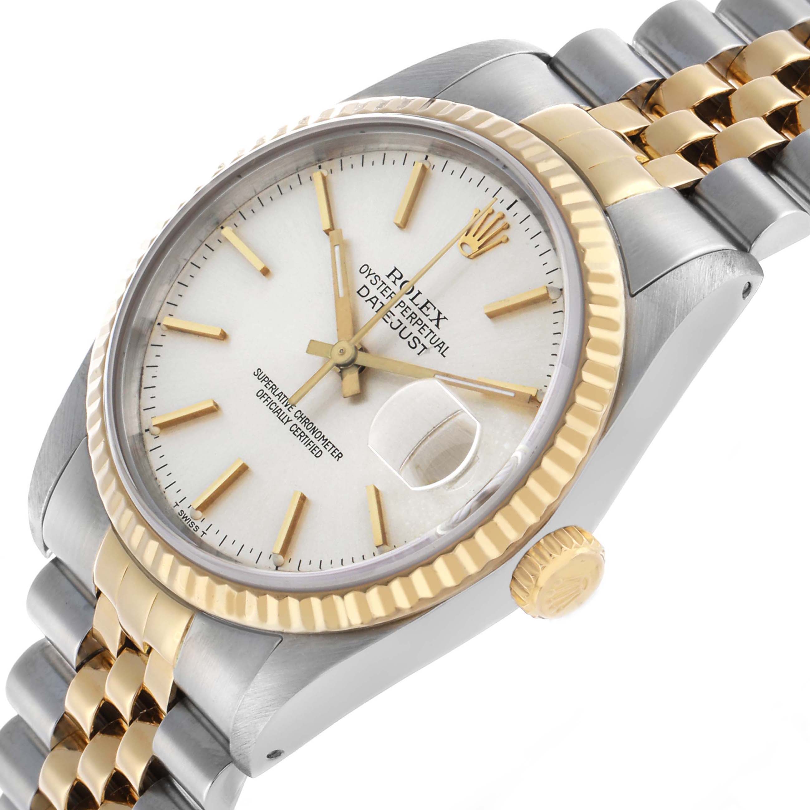 The Rolex Datejust 16233 Men's Steel and Gold (two tone) Silver Dial watch is shown at an angle displaying the face, fluted bezel, crown, and part of the two-tone bracelet.