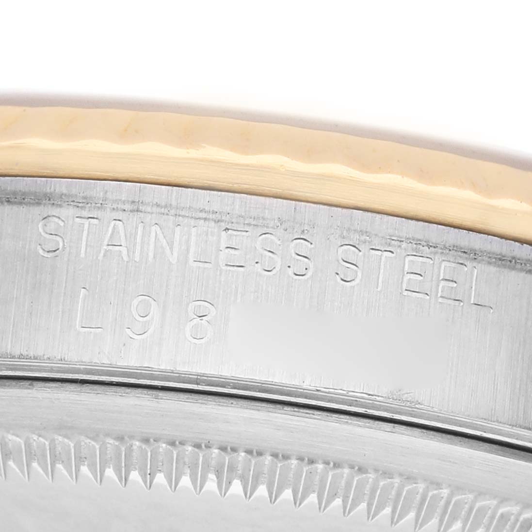 The image shows a close-up of the case side of a Rolex Datejust 16233 Men's Steel and Gold (two tone) Silver Dial, highlighting the stainless steel engraving.