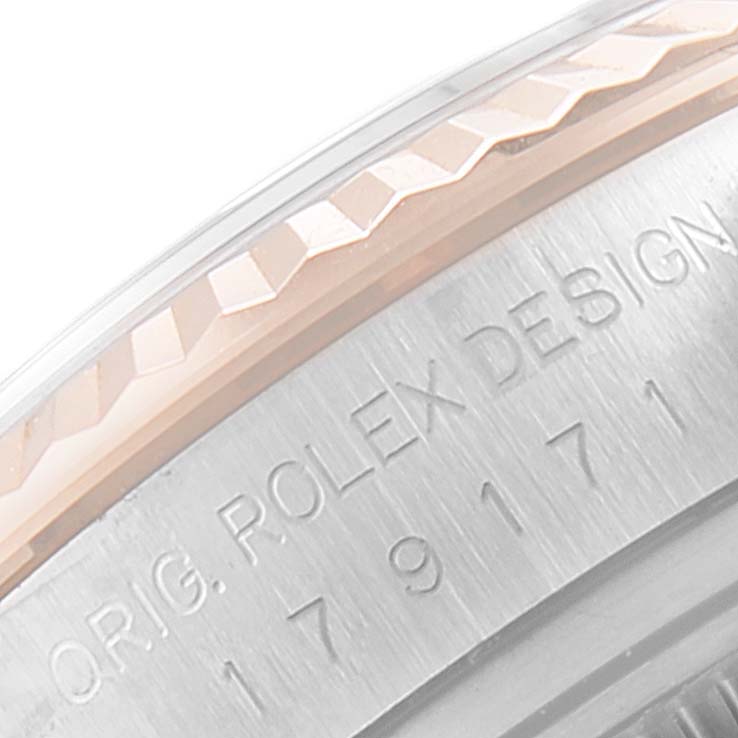 The image shows a close-up of the flange and engraved text on the side of a Rolex Datejust 179171 Women's Steel and Gold (two tone) White Dial 179171 Women's Steel and Gold (two tone) White Dial watch.