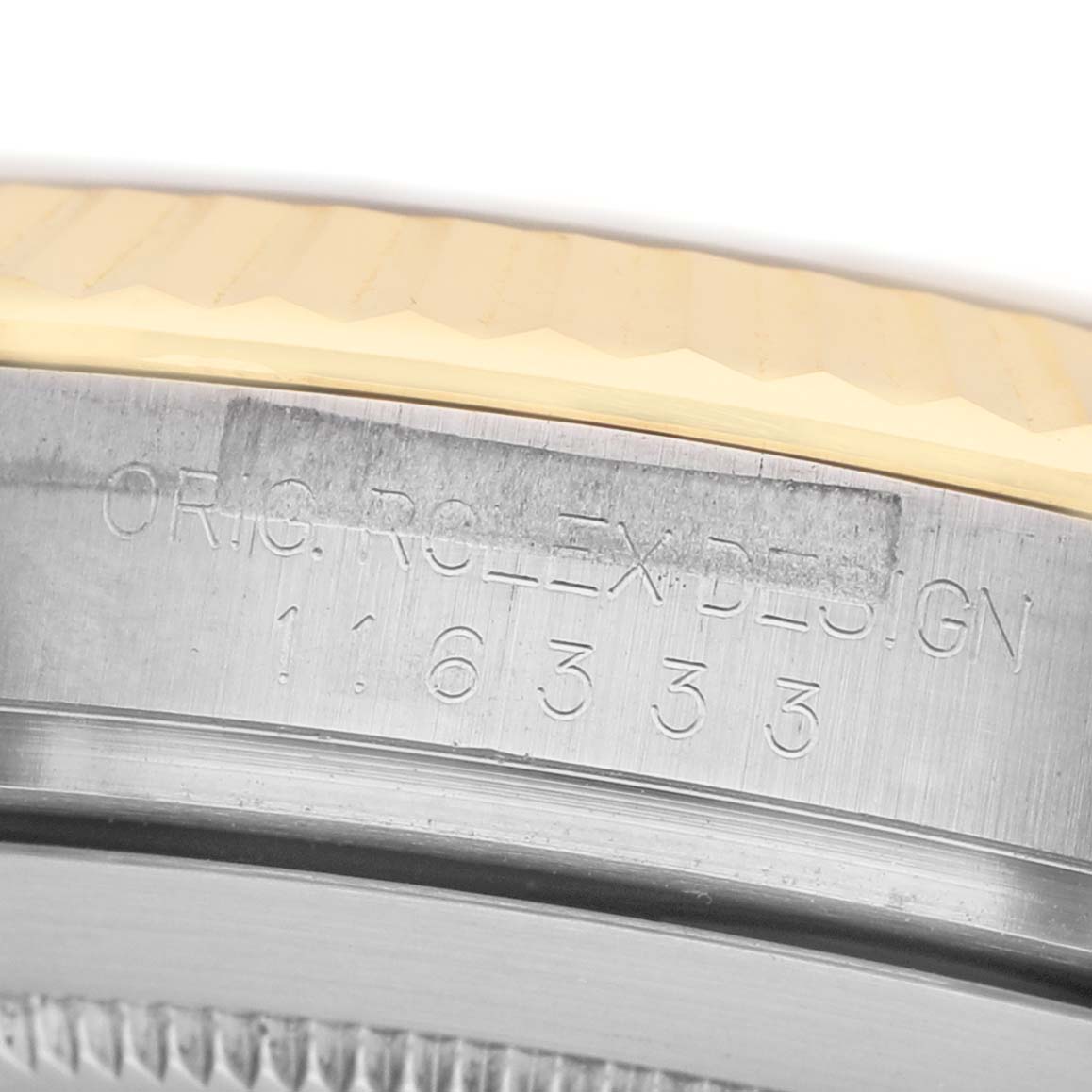 The image shows a close-up of the engraved side of a Rolex Datejust 41 116333 Men's Steel and Gold (two tone) Black Dial bezel and case edge.