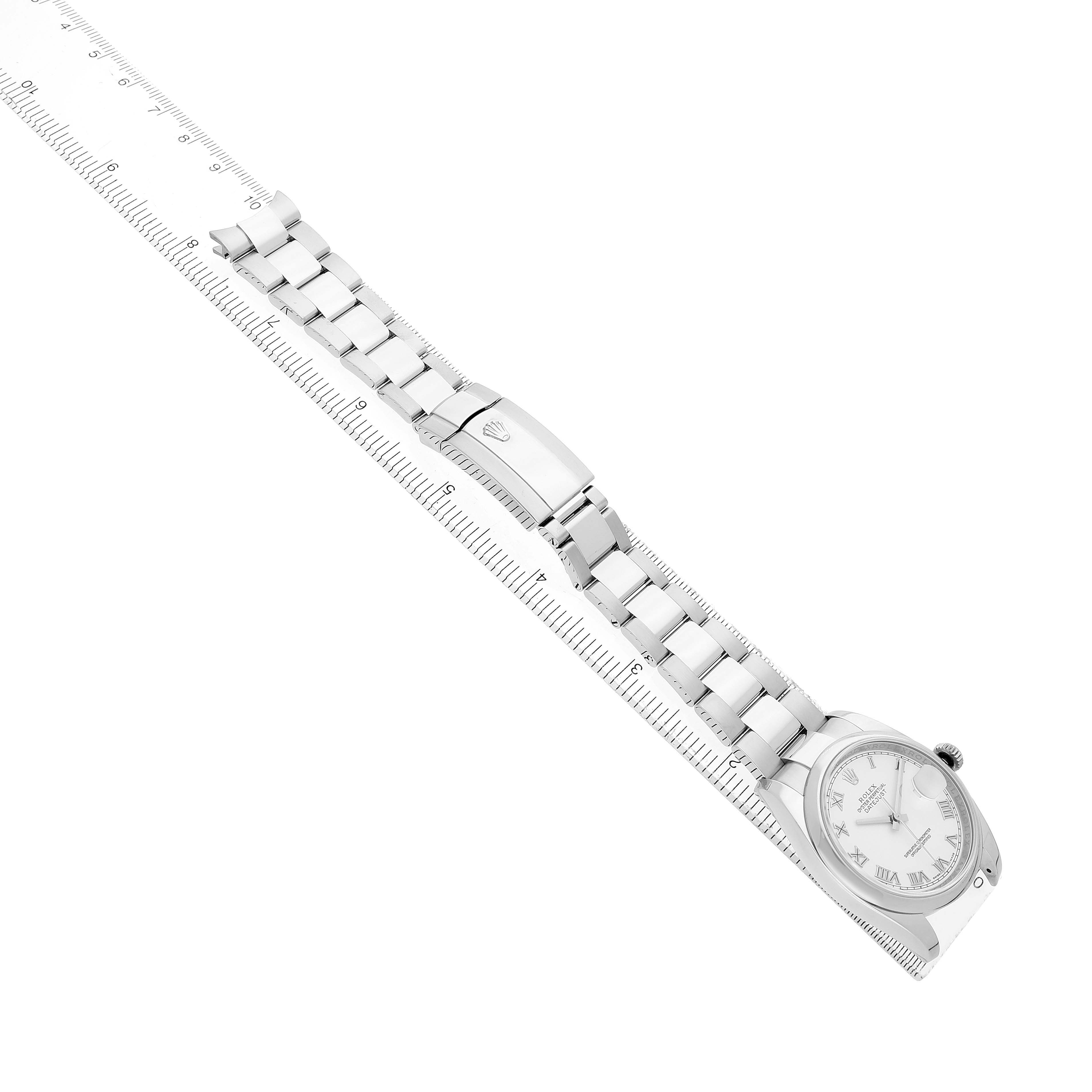 The Rolex Datejust 116200 Men's Stainless Steel White Dial watch is shown at an oblique angle displaying the face, bracelet, and clasp alongside a measuring ruler.