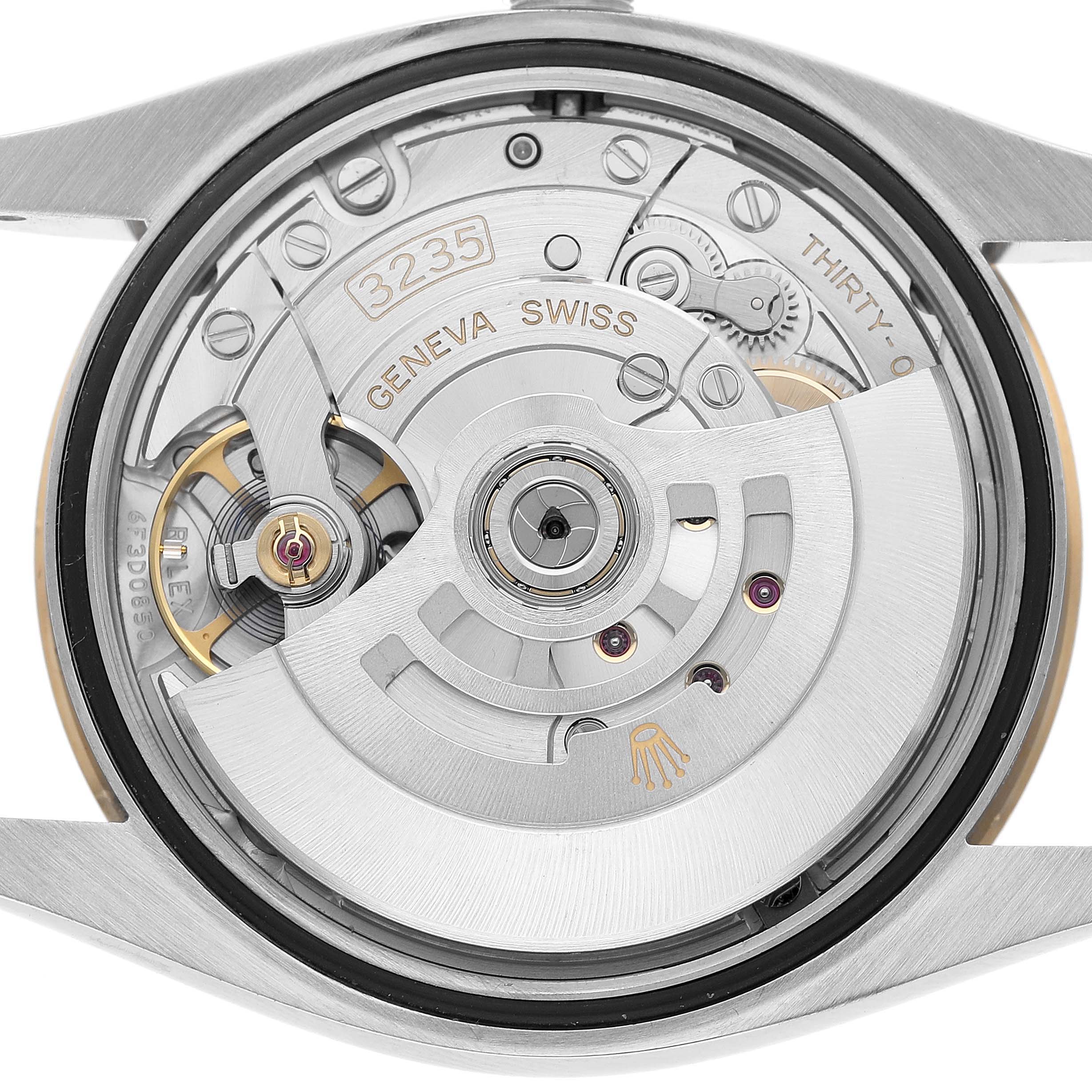 The image shows the movement of a Rolex Datejust 126233 Men's Steel and Gold (two tone) Black Dial from a back view, highlighting the rotor and main components.