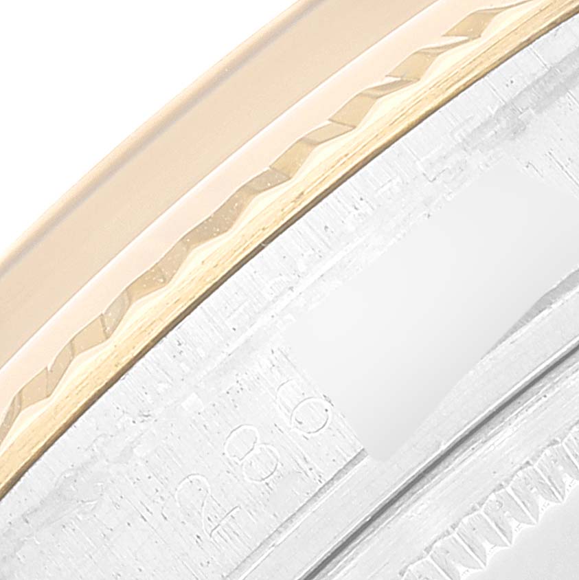 This close-up image shows the fluted bezel and part of the case of a Rolex Datejust 1601 Men's Steel and Gold (two tone) Champagne Dial 1601 Men's Steel and Gold (two tone) Champagne Dial watch.