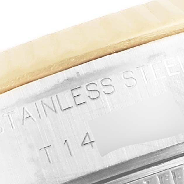 This close-up image shows the engraved text on the stainless steel case of a Rolex Datejust 69173 Women's Steel and Gold (two tone) Beige Dial 69173 Women's Steel and Gold (two tone) Beige Dial watch.