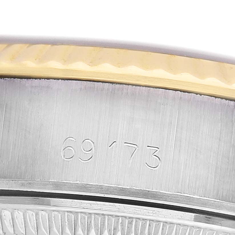 The image shows a close-up of the side of a Rolex Datejust 69173 Women's Steel and Gold (two tone) Silver Dial, focusing on the bezel and edge of the case with a visible engraved number.