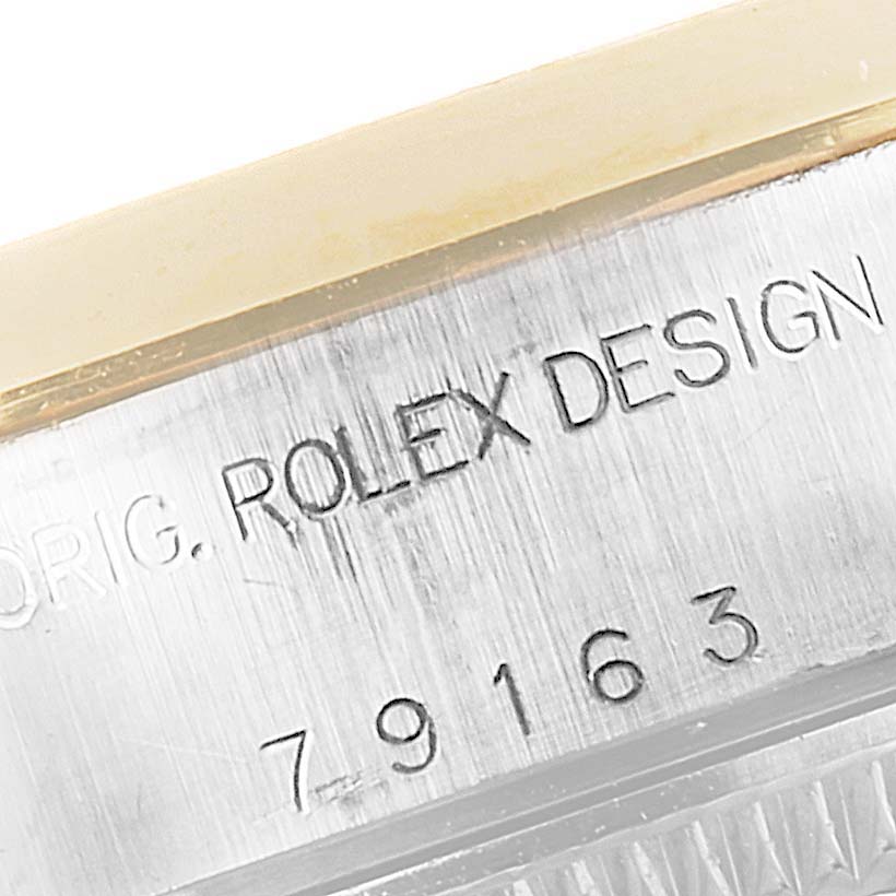 This close-up image shows the engraved serial number and "Rolex Design" text on the case of a Rolex Datejust 79163 Women's Steel and Gold (two tone) White Dial 79163 Women's Steel and Gold (two tone) White Dial watch.