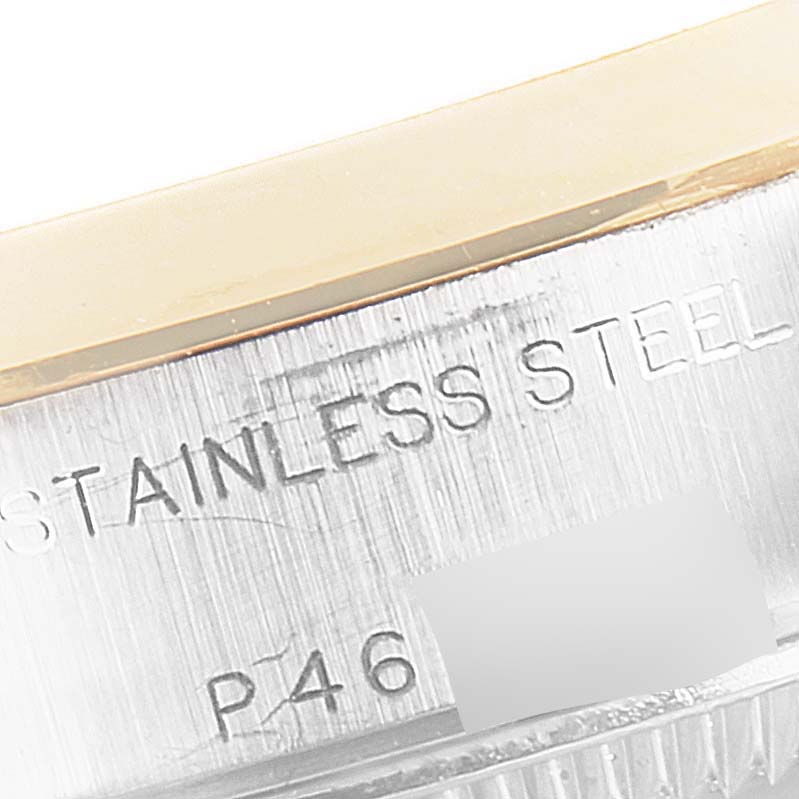 This close-up image of a Rolex Datejust 79163 Women's Steel and Gold (two tone) White Dial 79163 Women's Steel and Gold (two tone) White Dial watch shows part of the stainless steel case and serial information.