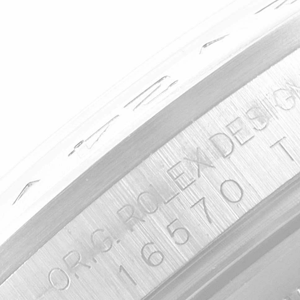The image shows a close-up of the case and bezel detailing with inscriptions on the Rolex Explorer 16570 Men
s Stainless Steel White Dial 16570 Men
s Stainless Steel White Dial model watch.