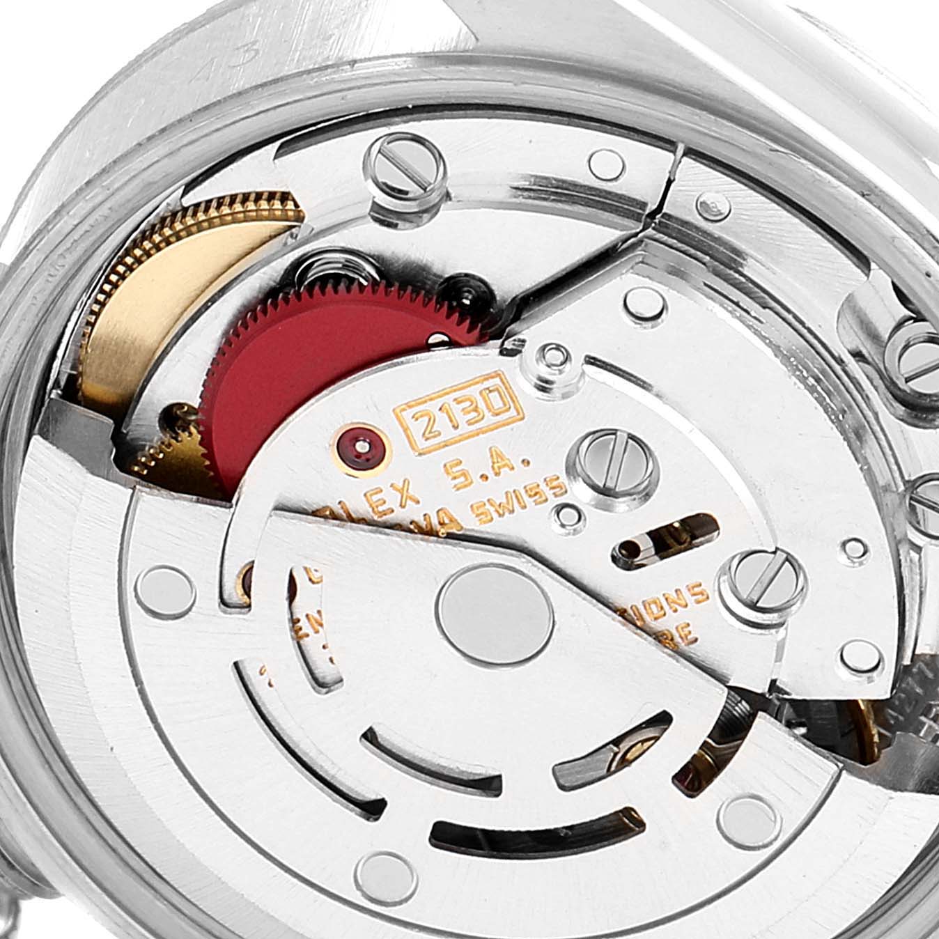 The image shows the internal mechanism of a Rolex Oyster Perpetual 67243 Women's Steel and Gold (two tone) Silver Dial 67243 Women's Steel and Gold (two tone) Silver Dial watch, focusing on the movement and gears.