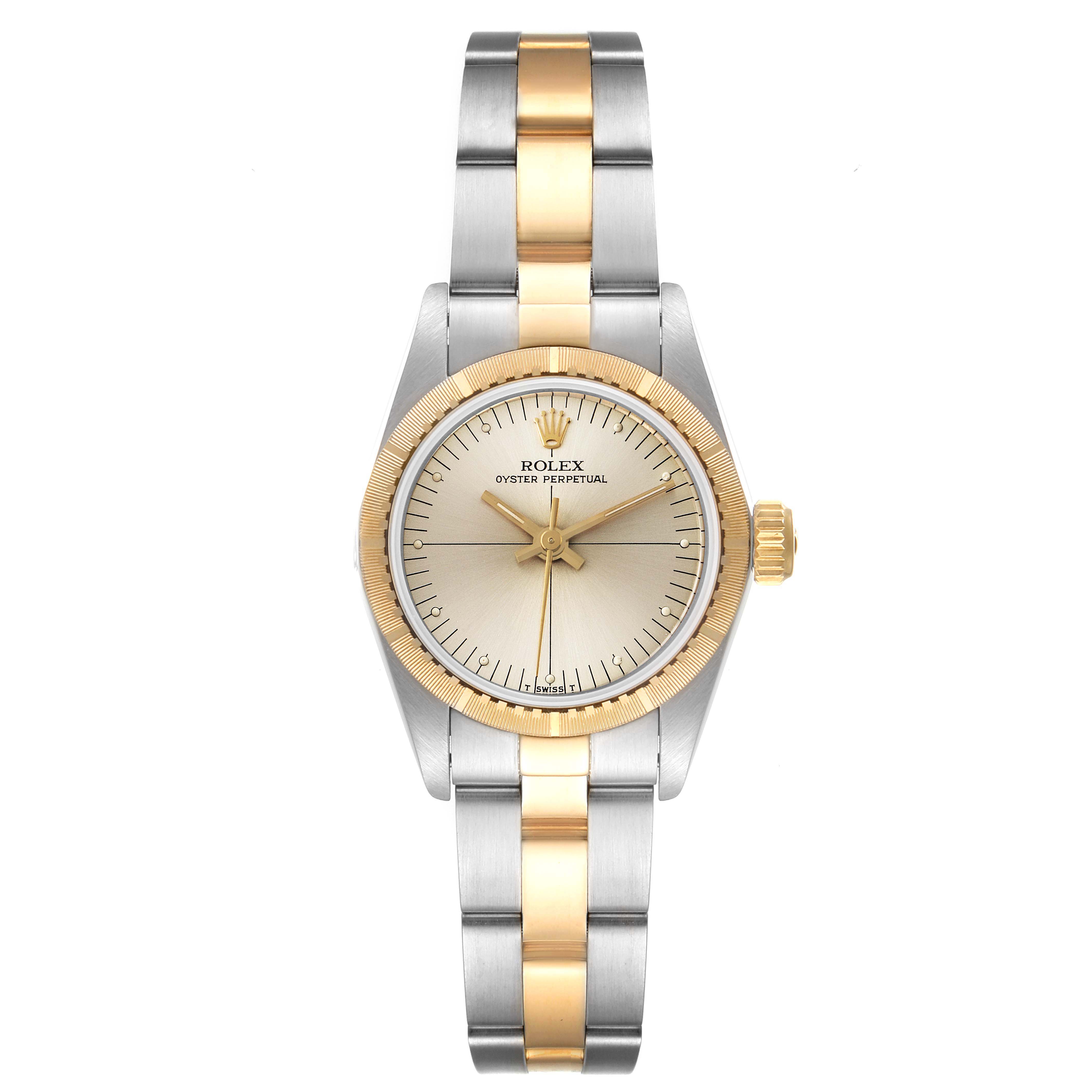 The image shows a Rolex Oyster Perpetual 67243 Women's Steel and Gold (two tone) Silver Dial 67243 Women's Steel and Gold (two tone) Silver Dial watch from a top-down angle, highlighting its two-tone bracelet and gold-accented bezel and crown.