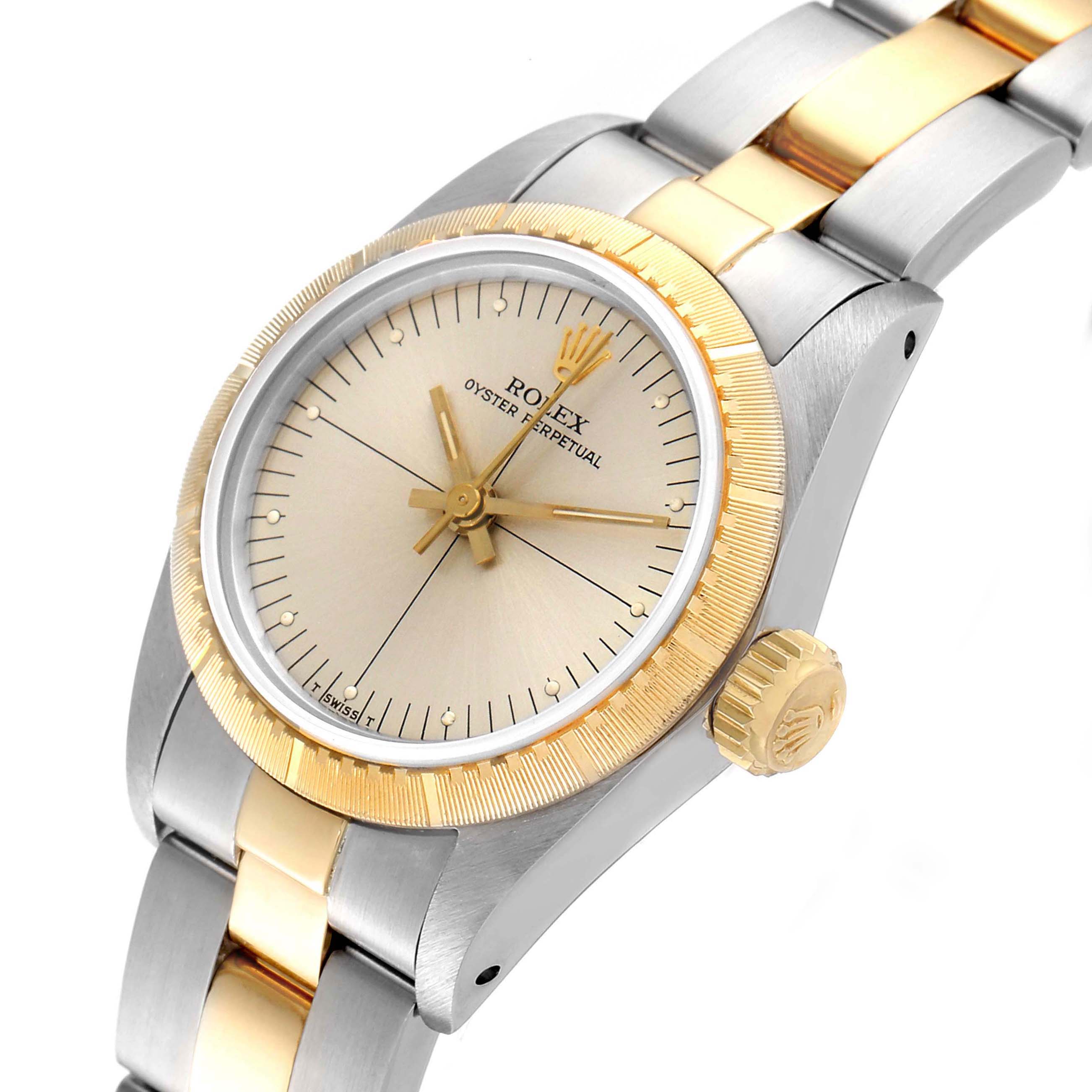 This image shows the face and crown of a Rolex Oyster Perpetual 67243 Women's Steel and Gold (two tone) Silver Dial 67243 Women's Steel and Gold (two tone) Silver Dial watch at an angled view.