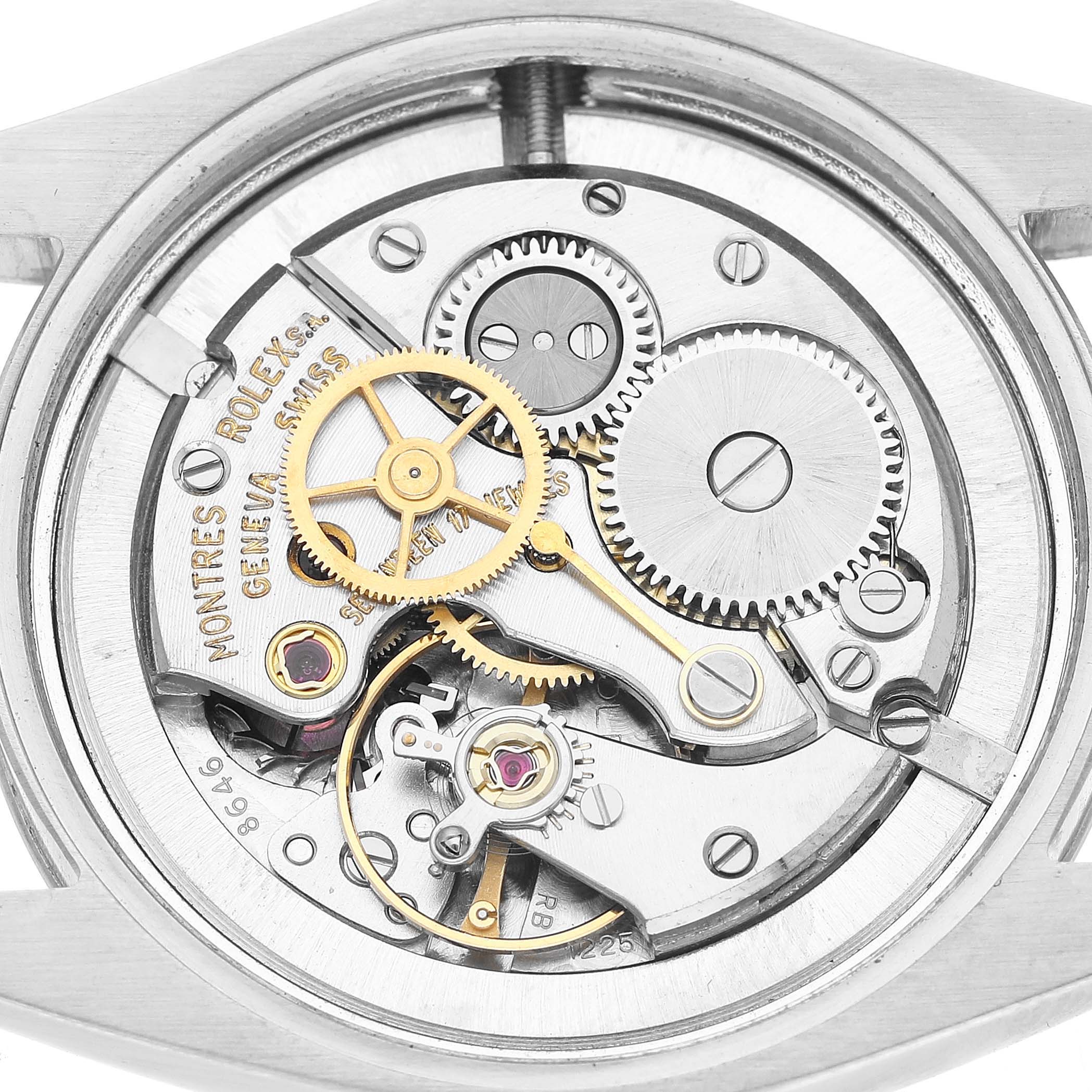 The image shows the movement mechanism of a Rolex Vintage Collection 6427 Men's Stainless Steel Silver Dial watch viewed from the back, highlighting gears and components.