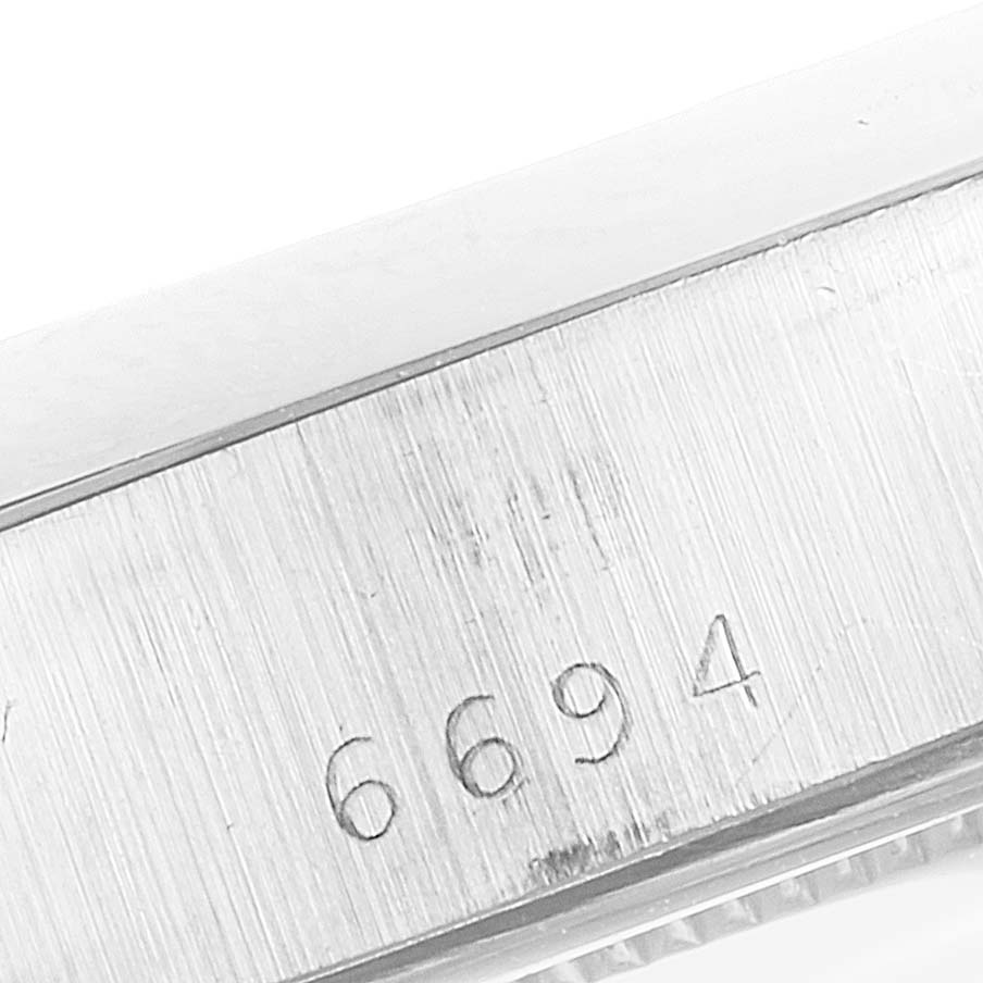 This close-up image shows the case side with the model number "6694" engraved on the Rolex Vintage Collection 6694 Men
s Stainless Steel Black Dial 6694 Men
s Stainless Steel Black Dial watch.