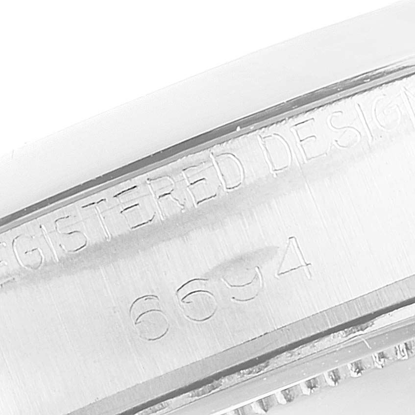 This image shows a close-up of the side of a Vintage Collection Rolex watch, highlighting its engraved model number "6694."