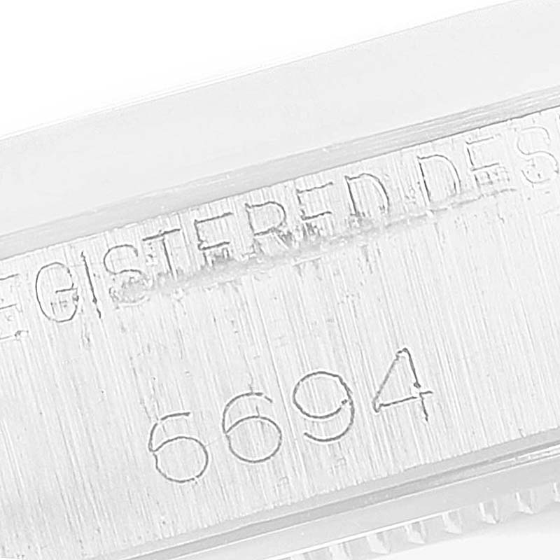 The image shows a close-up of the case side with the engraved numbers "6694" from a Rolex Vintage Collection 6694 Men's Stainless Steel Silver Dial watch.