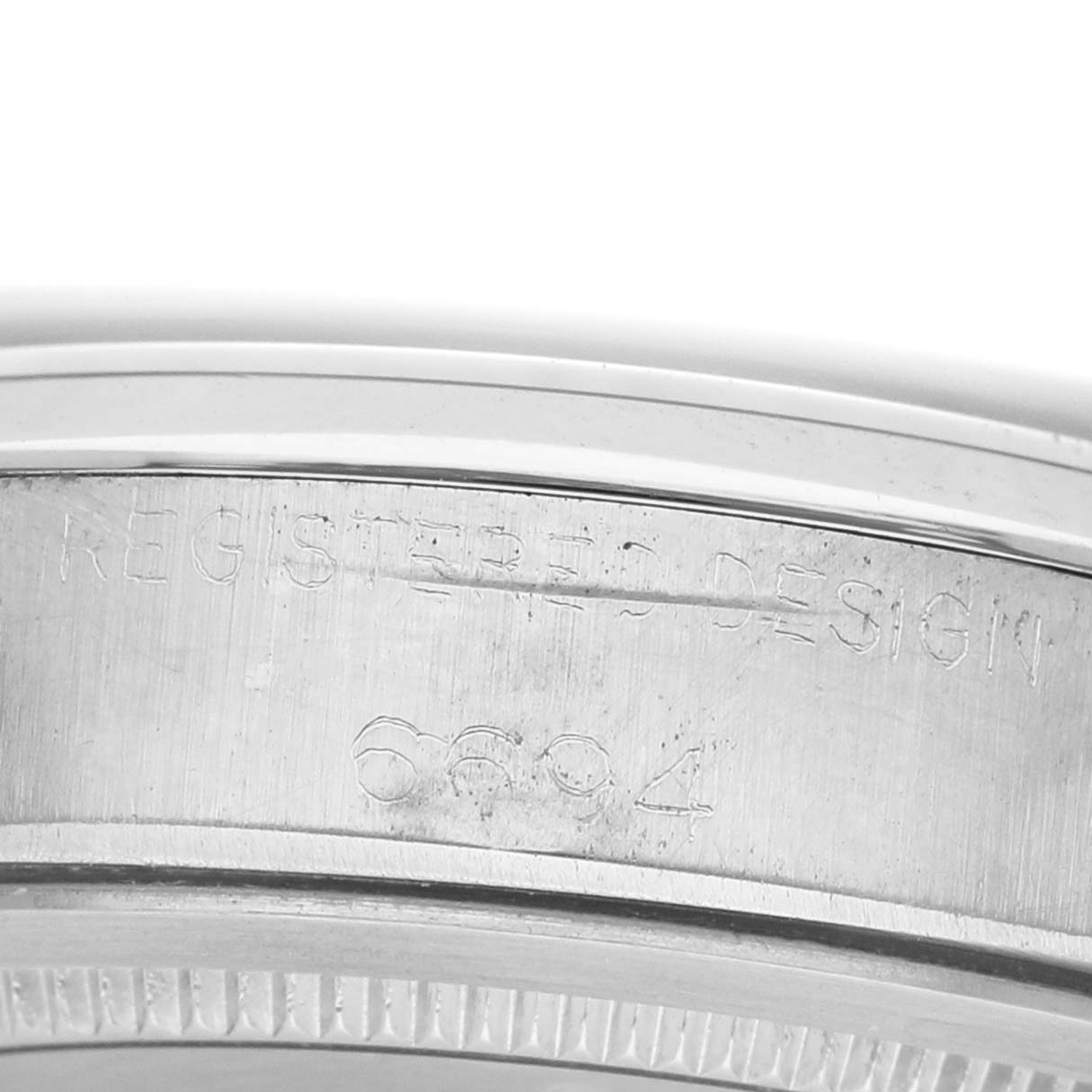 The image shows the engraved side of the case from a Rolex Vintage Collection 6694 Men's Stainless Steel Silver Dial watch, displaying the model number.