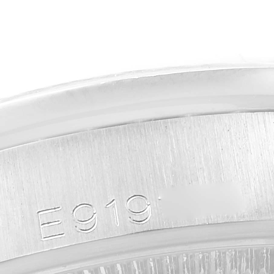This image shows a close-up of the serial number engraved on the edge of a Rolex President 68159 Women's White Gold Black Dial 68159 Women's White Gold Black Dial model watch case.