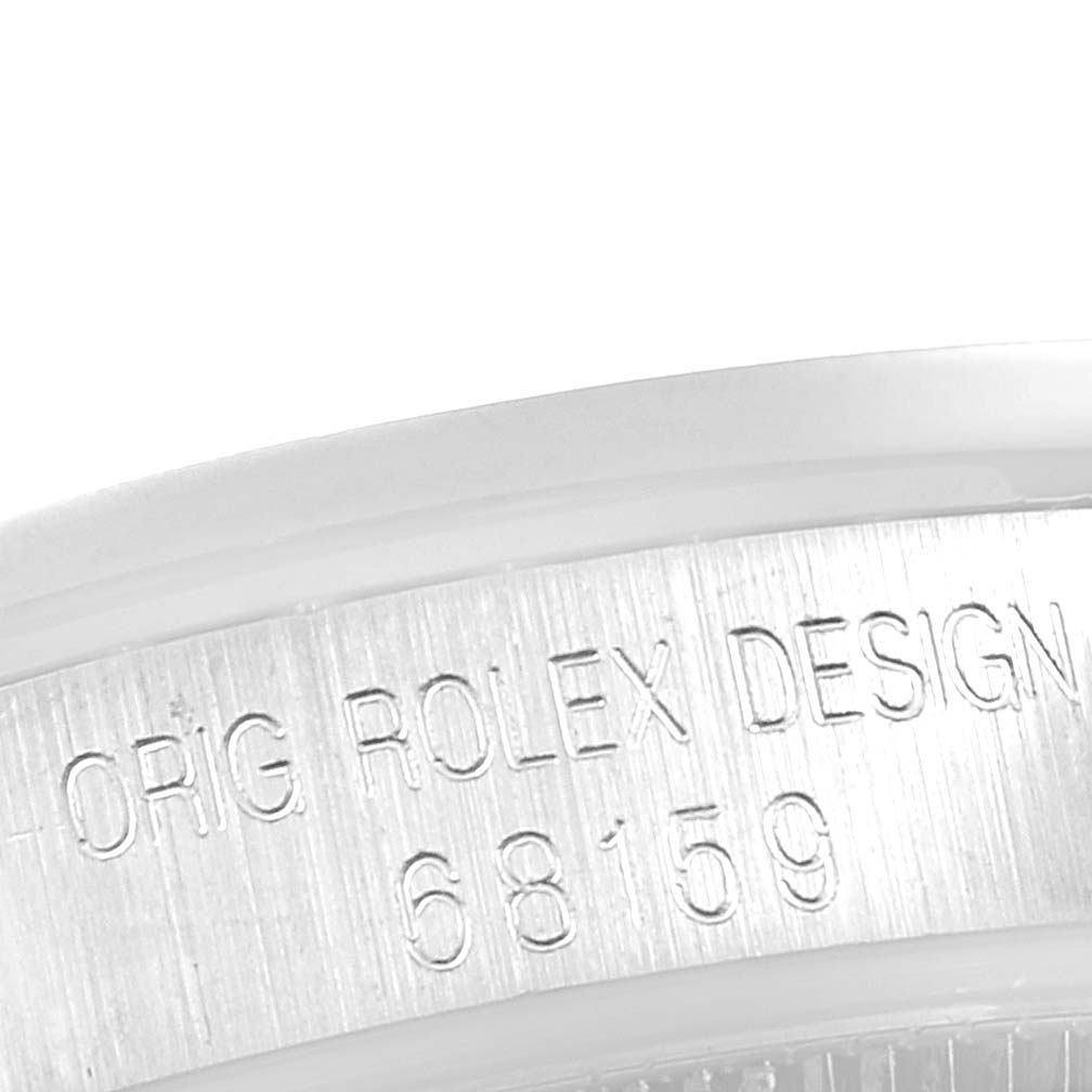 The image shows a close-up of the edge and engraved model number on the case of a Rolex President 68159 Women's White Gold Black Dial 68159 Women's White Gold Black Dial watch.