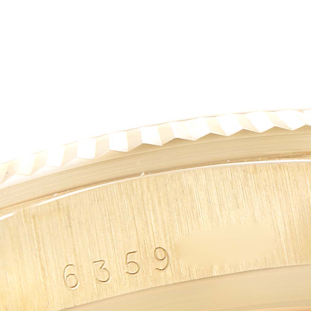 This close-up image shows the edge and part of the case with engraved numbers of a Rolex President 18038 Men
s Yellow Gold Champagne Dial 18038 Men
s Yellow Gold Champagne Dial model watch.