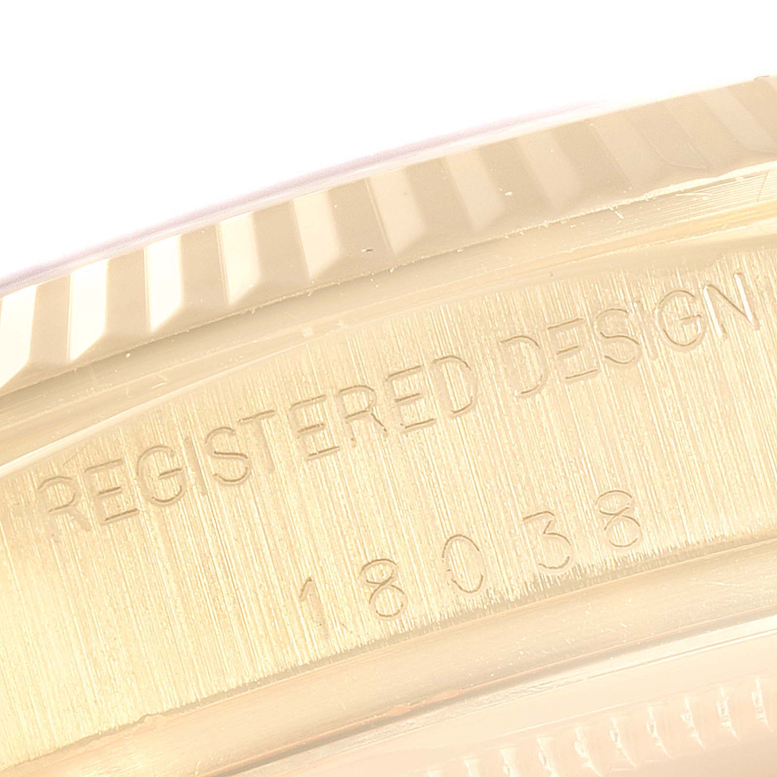 This close-up image shows the engraved case and bezel of a Rolex President 18038 Men
s Yellow Gold Champagne Dial 18038 Men
s Yellow Gold Champagne Dial model watch.