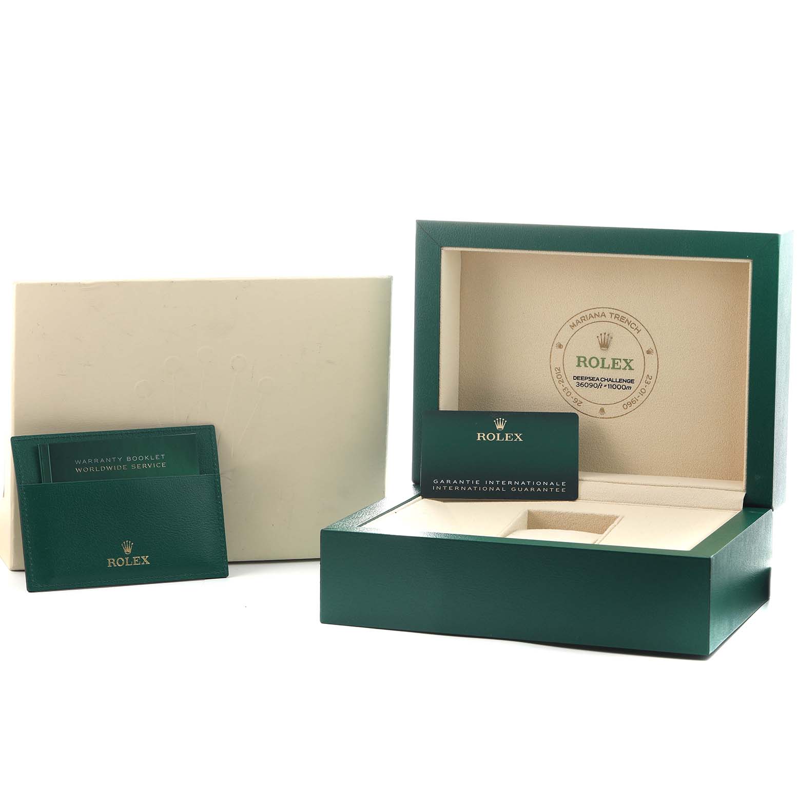 The image shows the Sea-Dweller Rolex packaging with an open box, warranty booklet, and guarantee card holder.