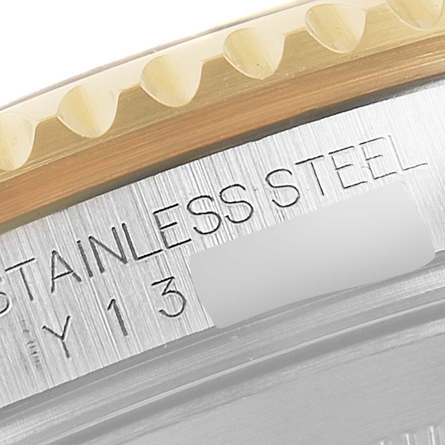 The image shows a close-up view of the bezel and stainless steel part of a Rolex Submariner 16613 Men's Steel and Gold (two tone) Blue Dial 16613 Men's Steel and Gold (two tone) Blue Dial watch.