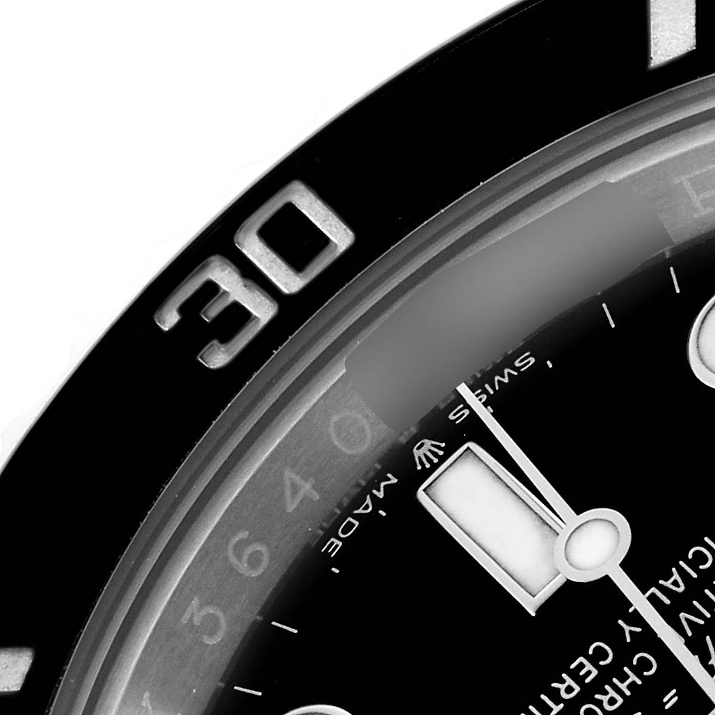 The image shows a close-up of the Rolex Submariner 124060 Men's Stainless Steel Black Dial watch's bezel, dial, and part of the minute hand.