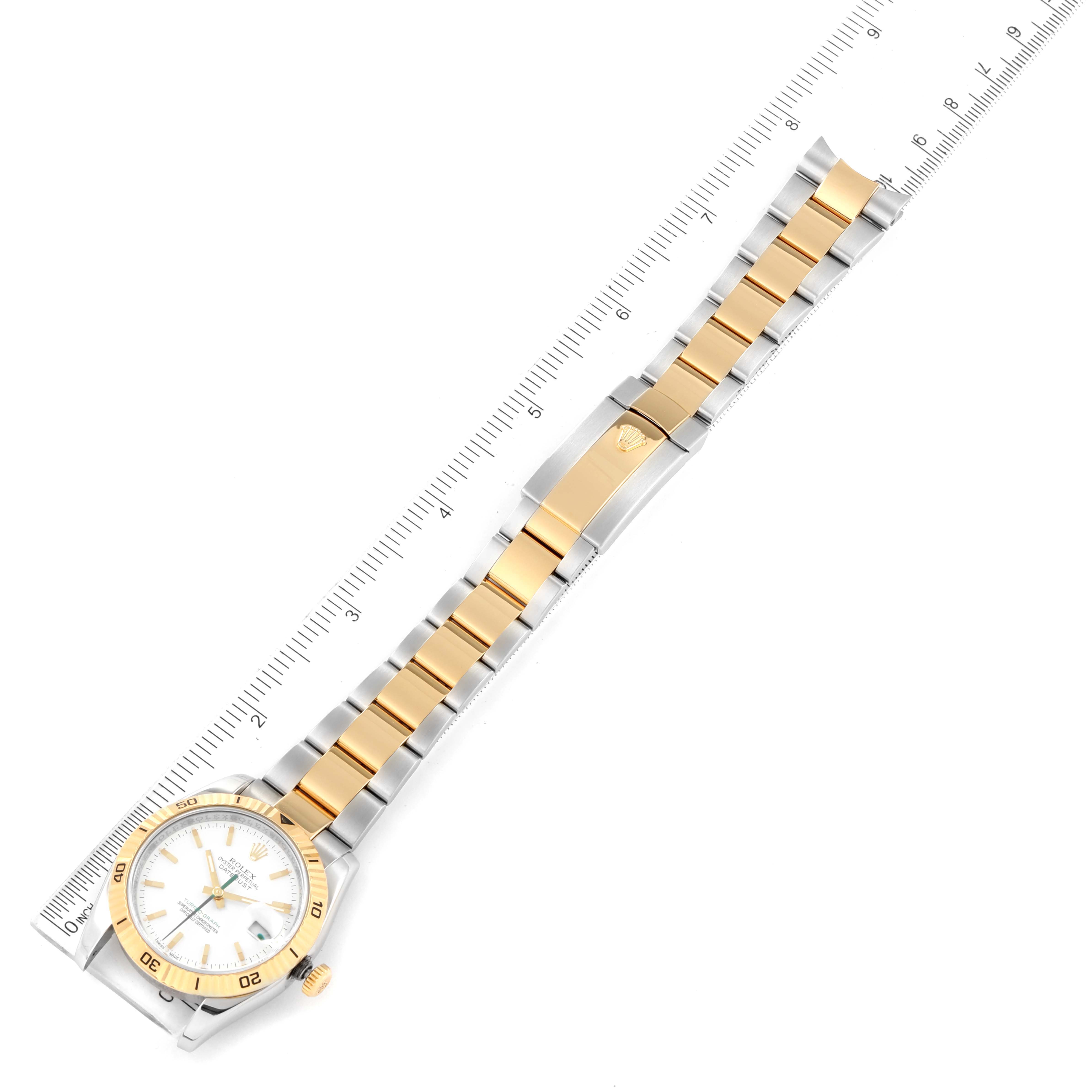 The image shows a Rolex Turn-o-Graph 116263 Men
s Steel and Gold (two tone) White Dial 116263 Men
s Steel and Gold (two tone) White Dial watch laid flat diagonally, displaying the face, bezel, crown, and entire bracelet with a ruler for scale.