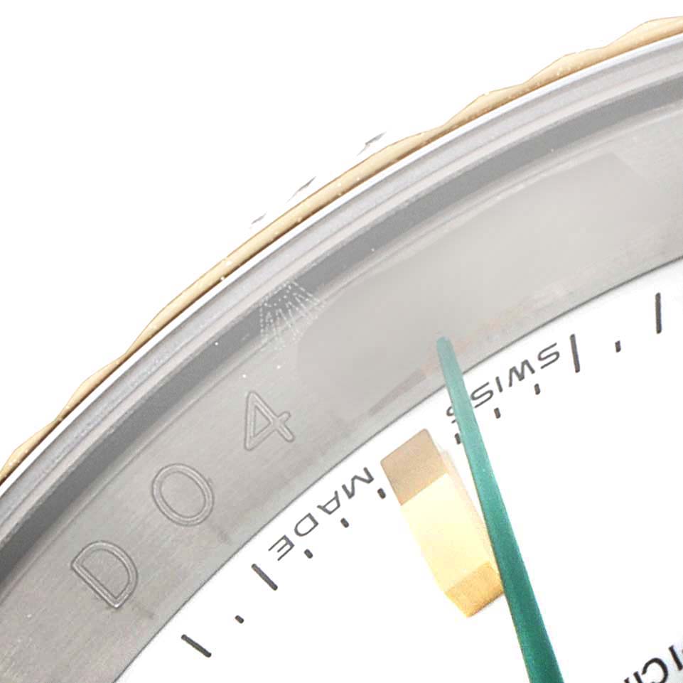 The image shows a close-up of the Turn-o-Graph model by Rolex, focusing on the bezel, part of the dial, and green second-hand.