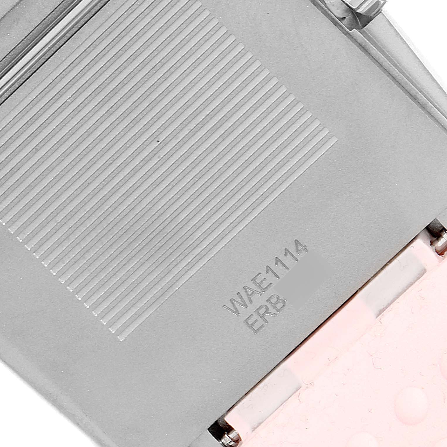 This is the back case of a Tag Heuer Monaco WAE1114.FT6011 Women's Titanium Mother of Pearl Dial WAE1114.FT6011 Women's Titanium Mother of Pearl Dial watch, showing the model number engraved on it.