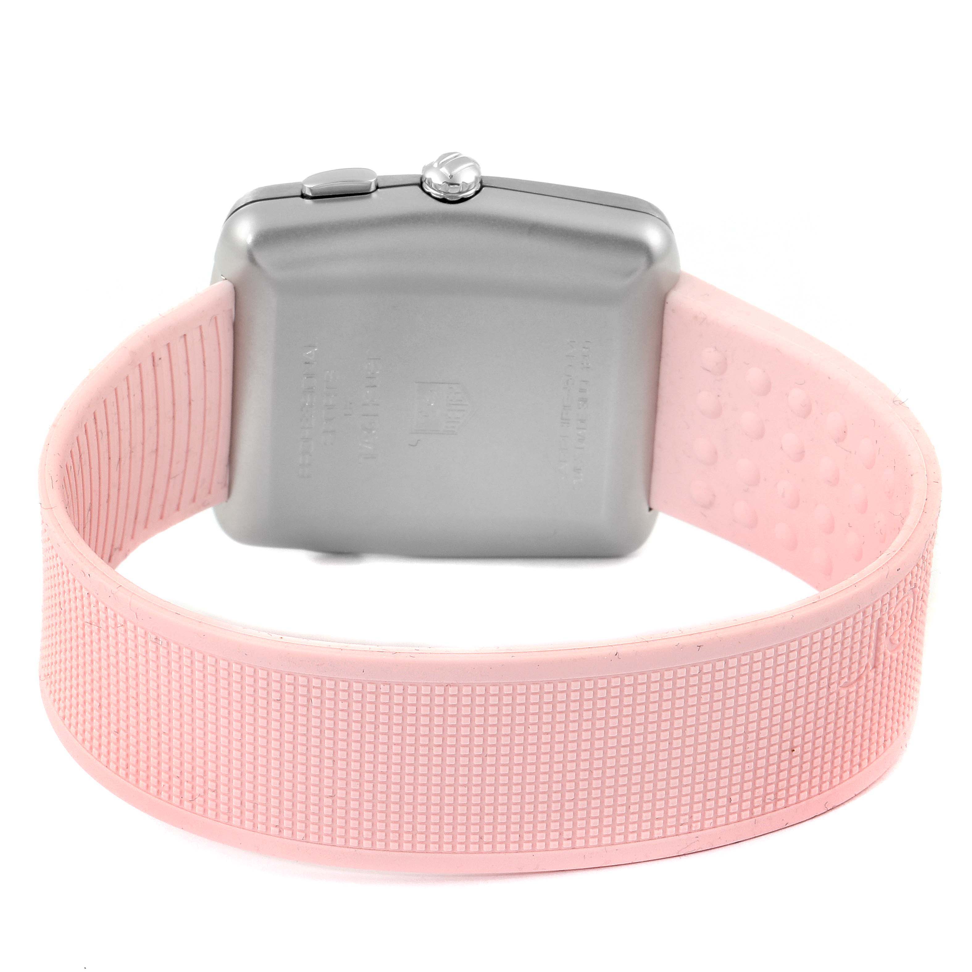 This image shows the back view of a Monaco model by Tag Heuer, featuring its case and pink strap.