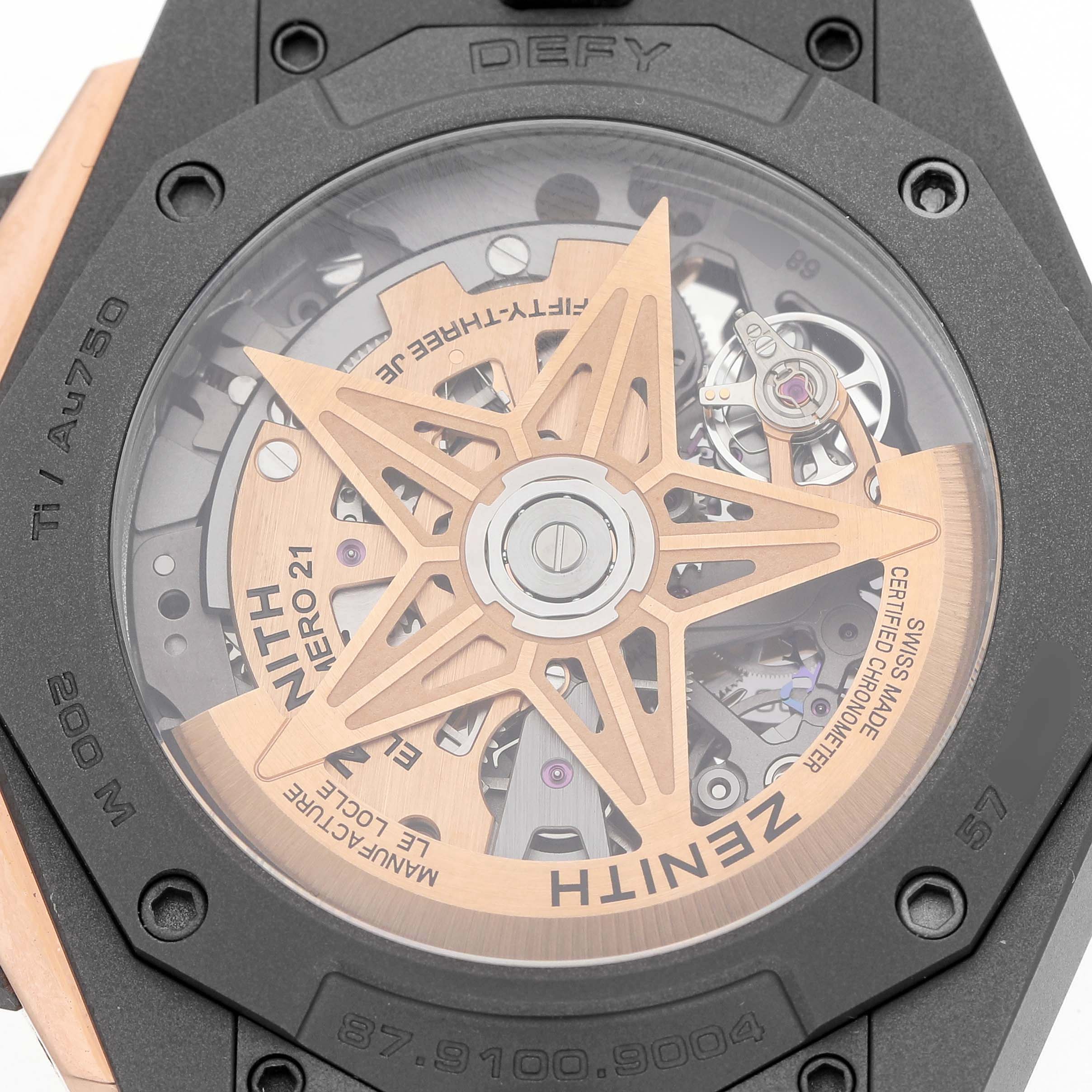 The image shows the back of a Zenith Defy 87.9100.9004/03.I001 Men's Titanium Grey Dial watch, highlighting the movement and rotor through its transparent case back.