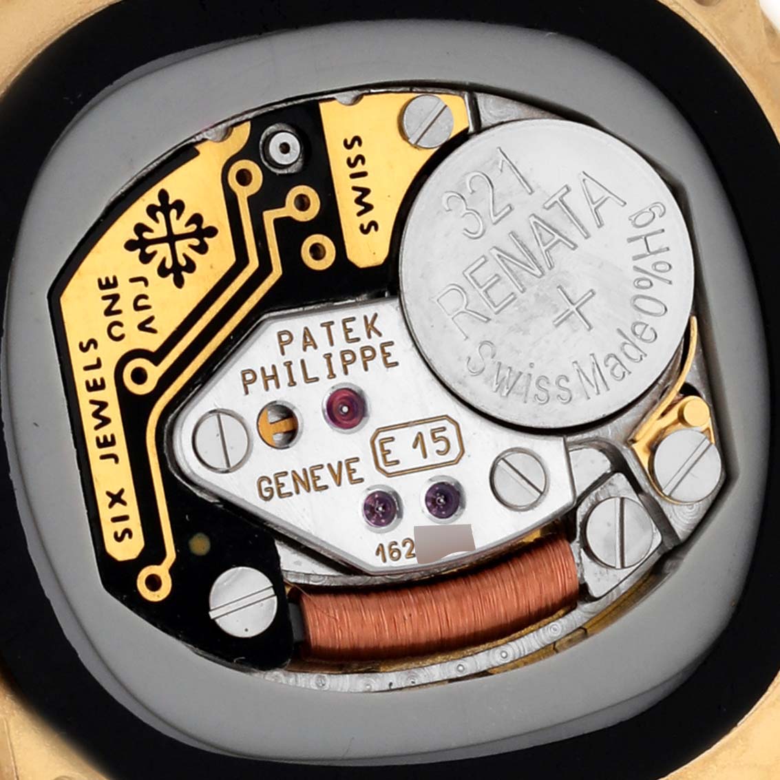 The image shows the internal movement of the Patek Philippe Golden Ellipse 4830J Women's Yellow Gold Mother of Pearl Dial 4830J Women's Yellow Gold Mother of Pearl Dial, highlighting the battery and electronic components.