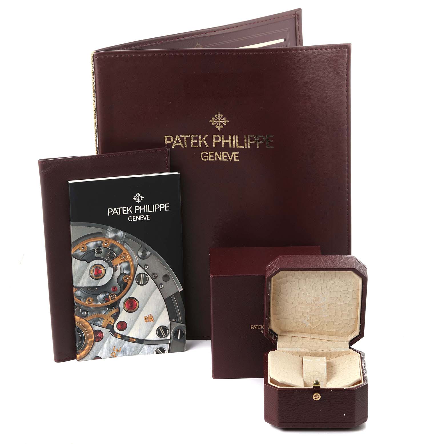 The image shows the packaging and documents for a Patek Philippe Golden Ellipse 4830J Women's Yellow Gold Mother of Pearl Dial 4830J Women's Yellow Gold Mother of Pearl Dial watch, including a box, booklet, and leather folder.