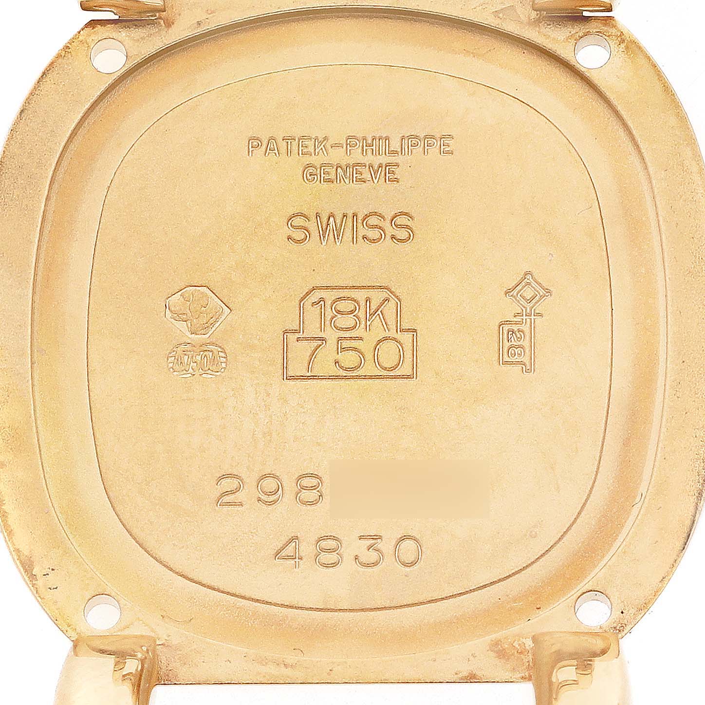 The image shows the inside case back of the Golden Ellipse model by Patek Philippe, featuring hallmarks and engravings.