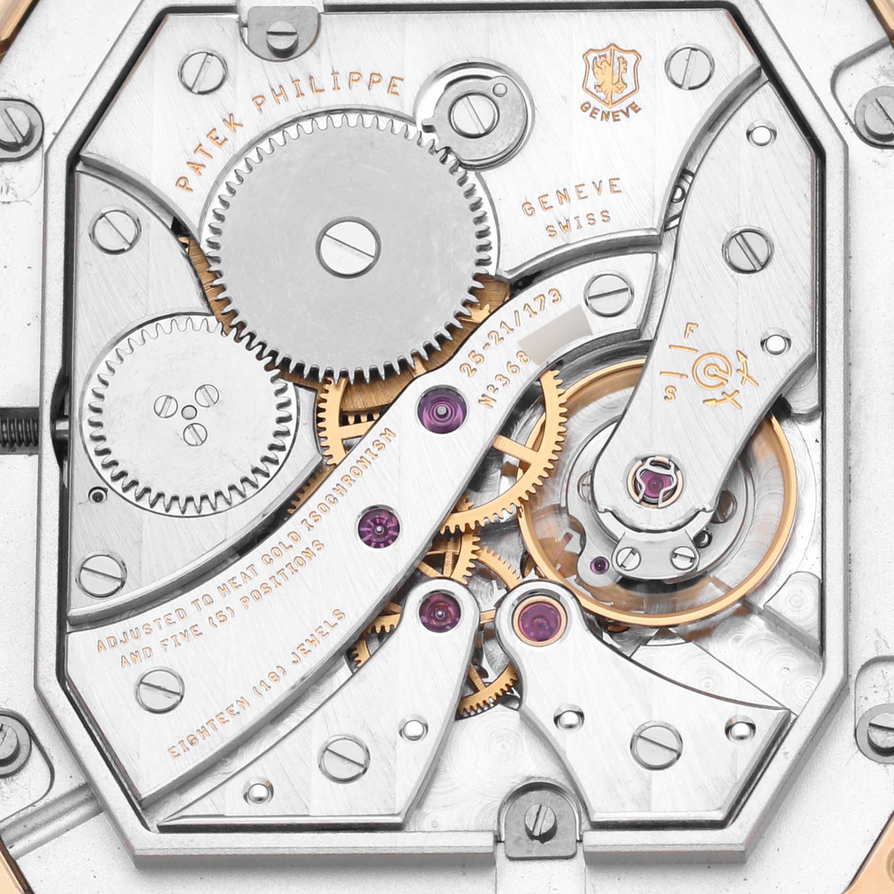 The image shows the intricate movement of a Patek Philippe Gondolo 5124J Men's Yellow Gold Silver Dial 5124J Men's Yellow Gold Silver Dial watch from a top-down angle, highlighting gears and engravings.