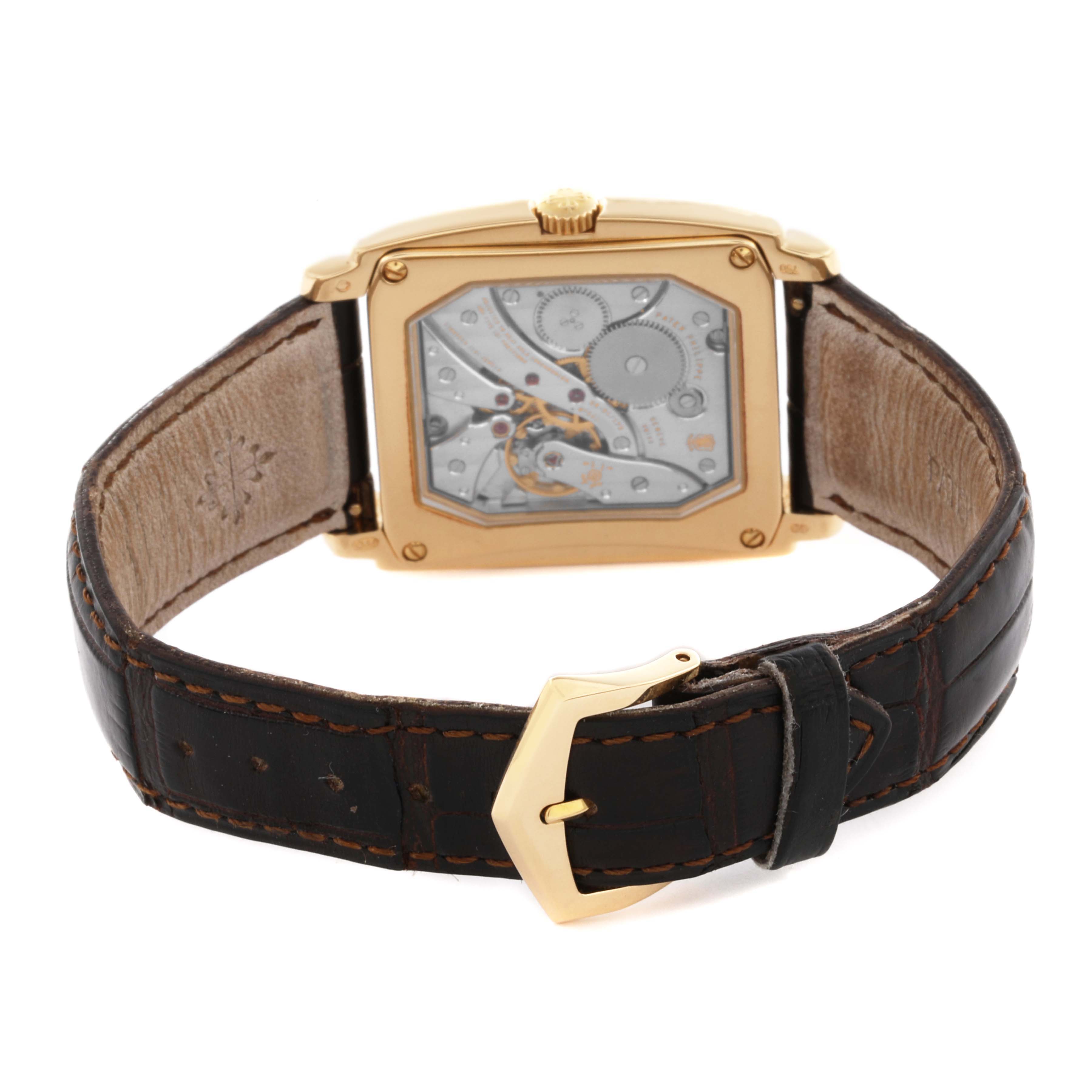 The image shows the back view of the Patek Philippe Gondolo 5124J Men's Yellow Gold Silver Dial 5124J Men's Yellow Gold Silver Dial watch, highlighting its mechanical movement and leather strap.