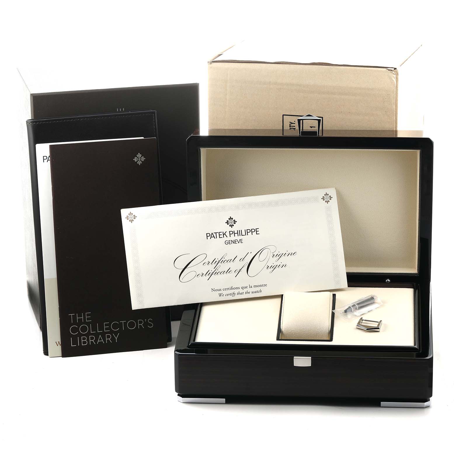 The image shows a Patek Philippe Complications 5320G Men's White Gold White Dial watch box with accessories, certificates, and packaging at an angle displaying contents.