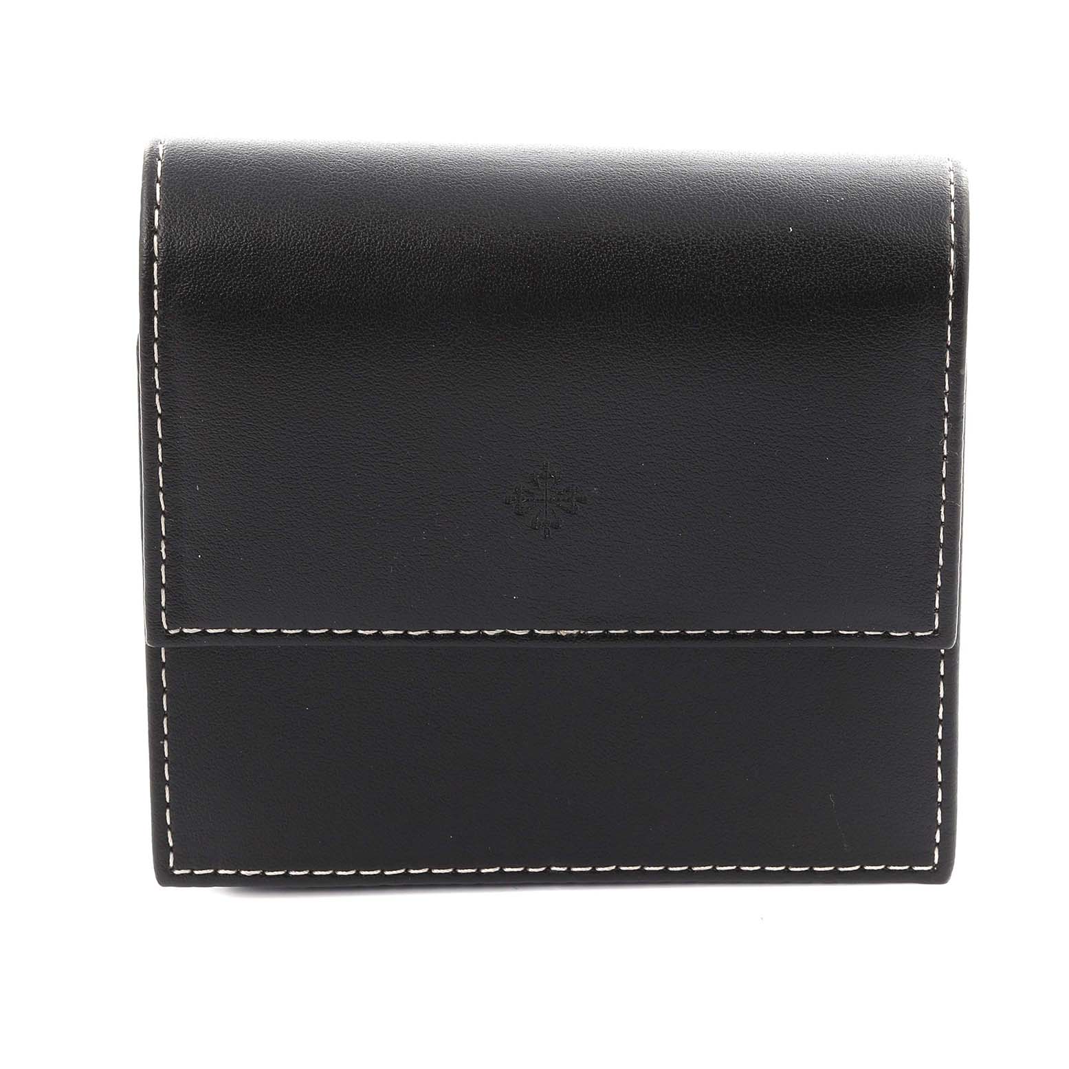 The image shows a black leather case for a Patek Philippe Twenty-4 4910/10A-011 Women's Stainless Steel Silver Dial 4910/10A-011 Women's Stainless Steel Silver Dial watch, featuring contrasting white stitching.