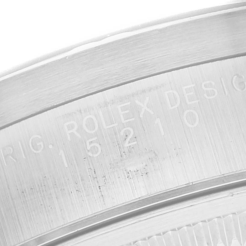 This image shows a close-up of the serial number engraving on the case of a Rolex Date 15210 Men's Stainless Steel Black Dial 15210 Men's Stainless Steel Black Dial model watch.